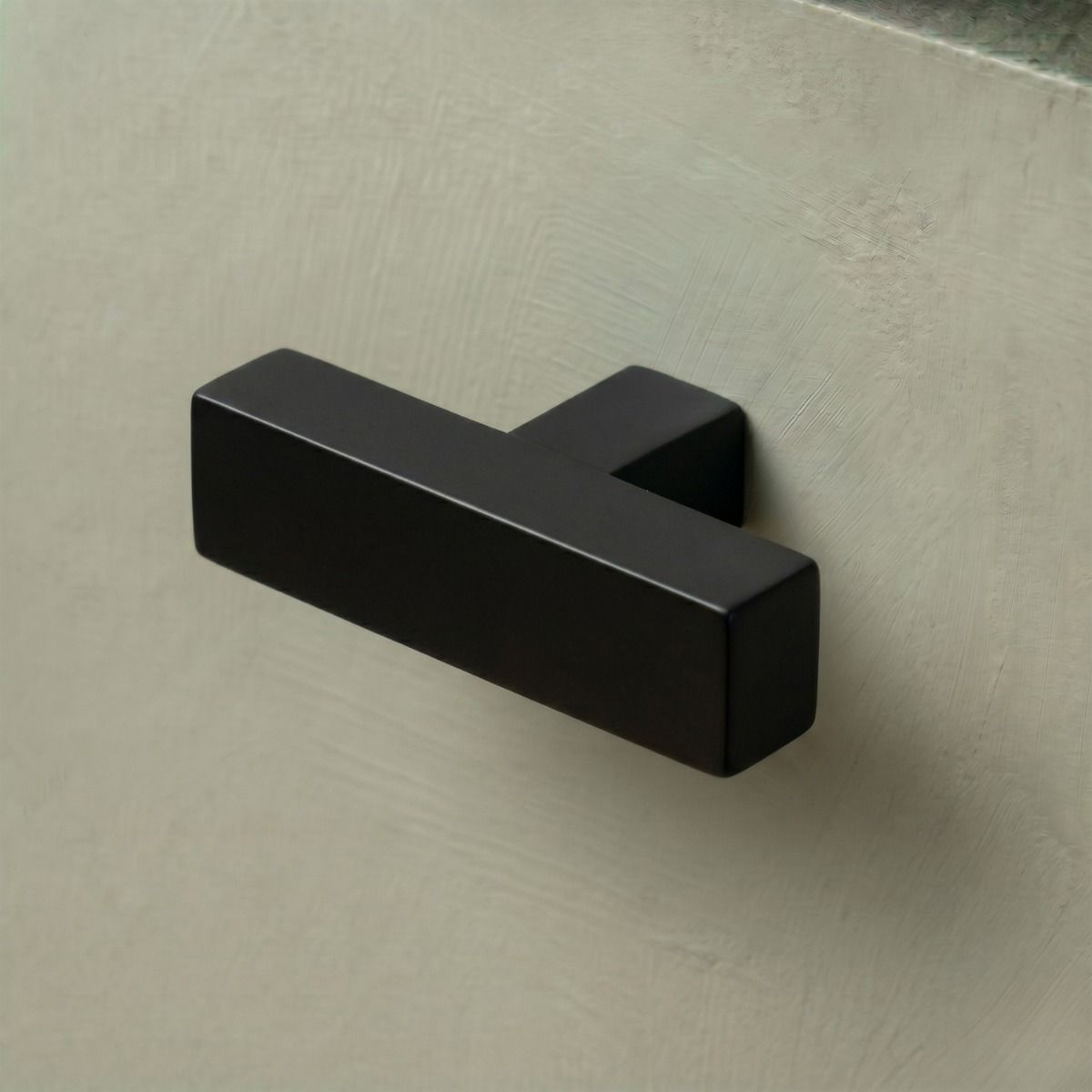 The Aged Brass "Kodiak" Heavyweight Block T-Bar Cabinet Handle Mounted on a Dark Blue Kitchen Cupboard Drawer - Digital Illustration 