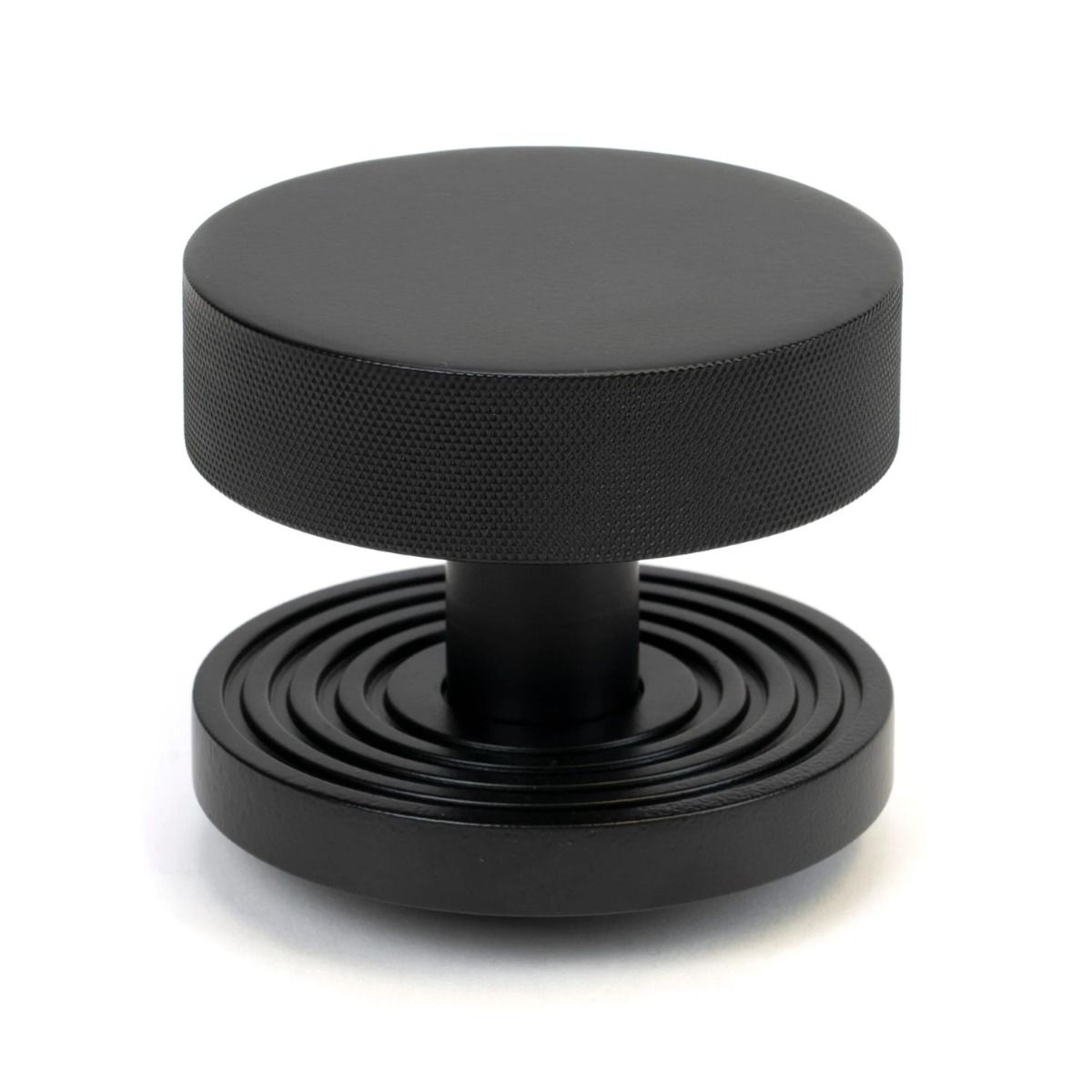 The Matt Black Knurled Centre Door Knob on a Beehive Rose Shown Upright on a White Background 