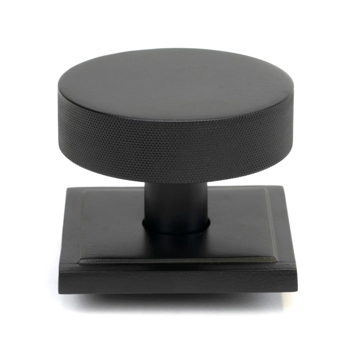 The Matt Black Knurled Centre Door Knob on a Square Rose Shown Upright on a White Background 