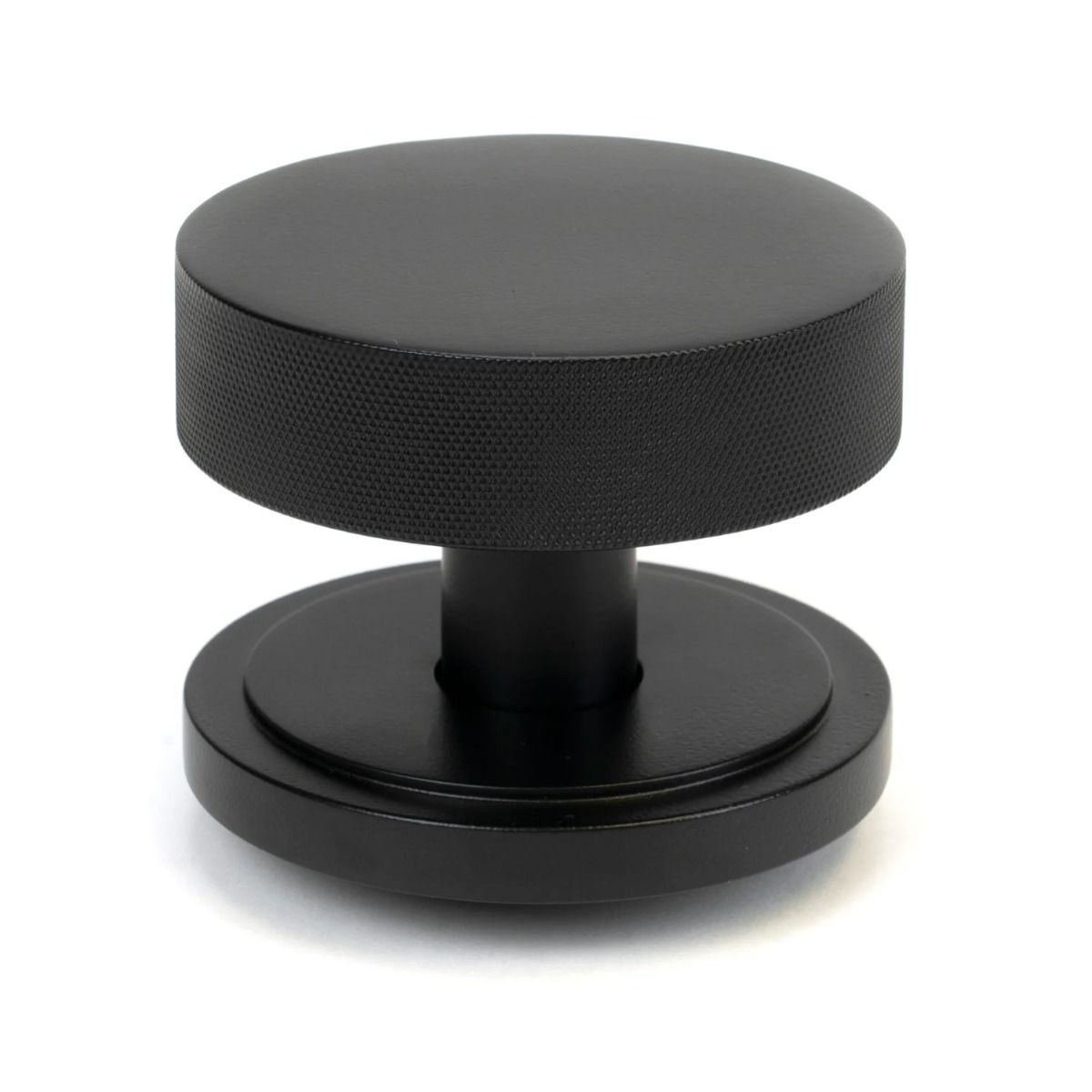 The Matt Black Knurled Centre Door Knob on an Art Deco Rose Shown Upright on a White Background 