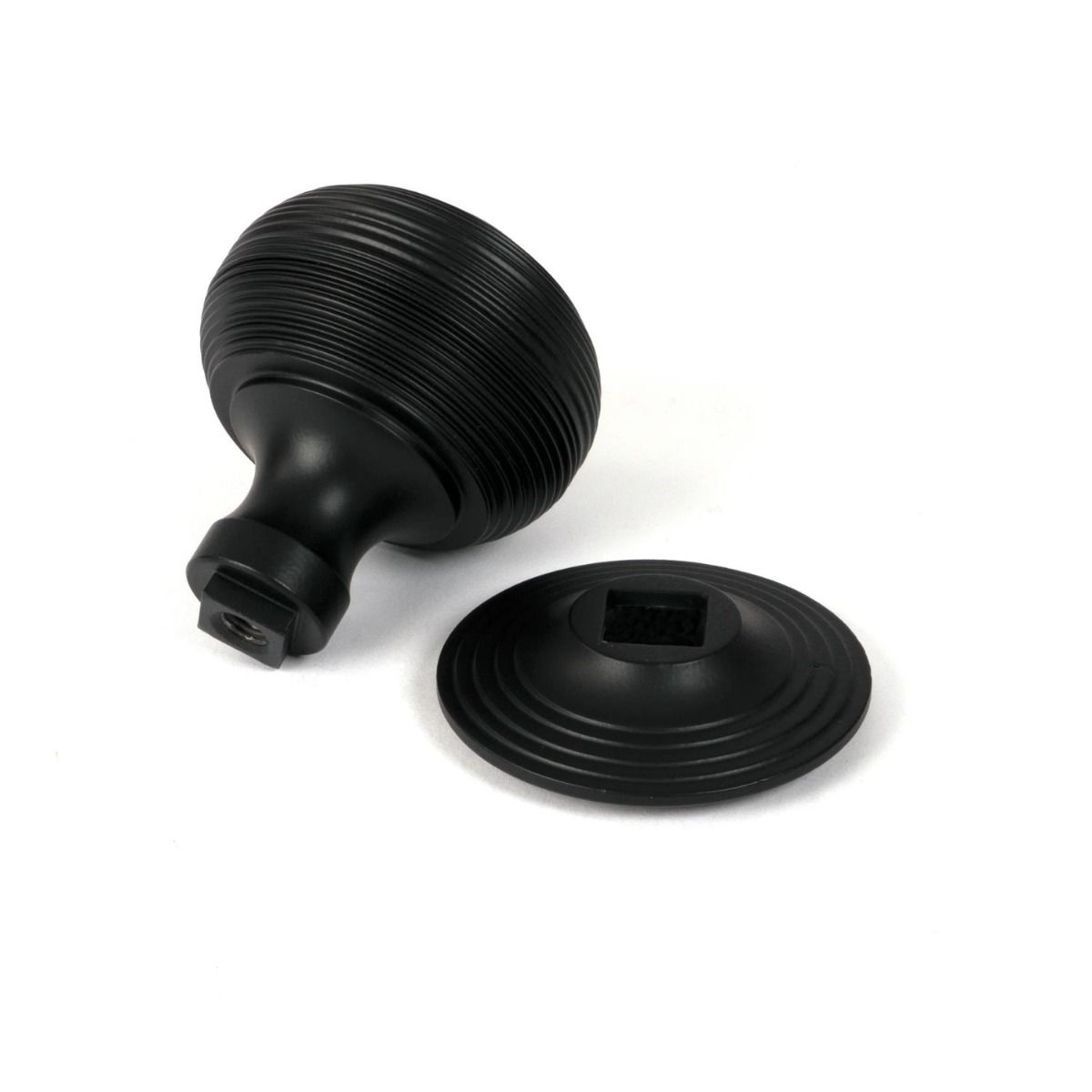 The Matt Black Traditional Beehive Centre Door Knob on a White Background Shown From Behind with Rose