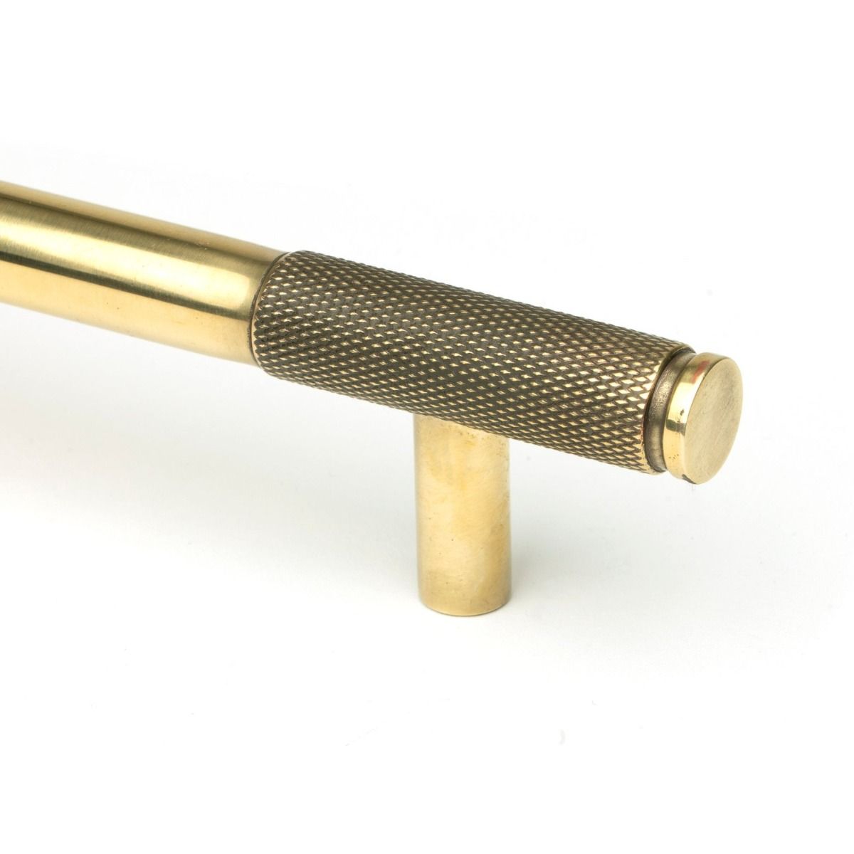 The Medium Half Knurled Cabinet Pull Handle in Aged Brass Looking Close up of the End of the Knurled Handle