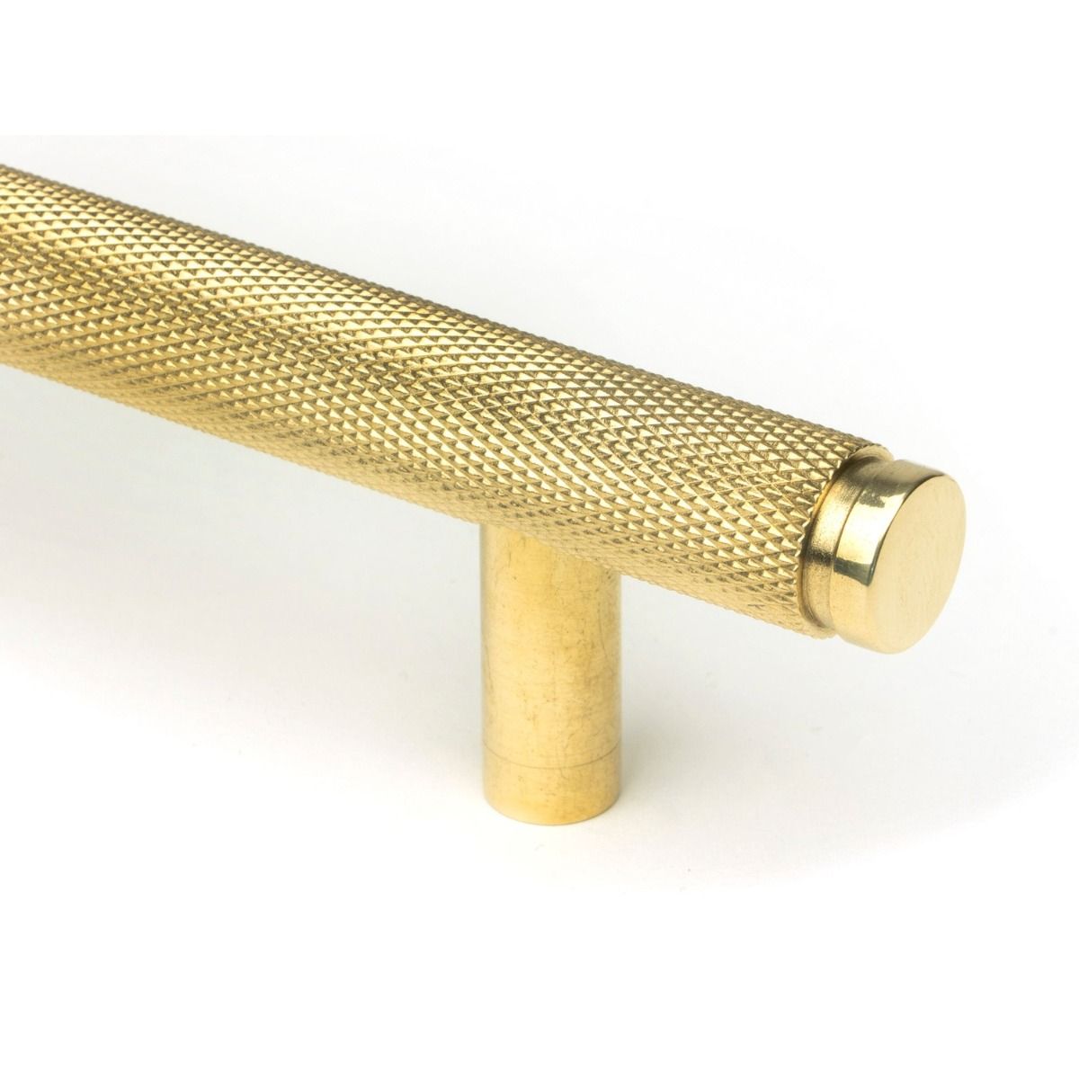 The Medium Knurled Cabinet Pull Handle in Polished Brass Showing a Close up of the Edge of the Handle