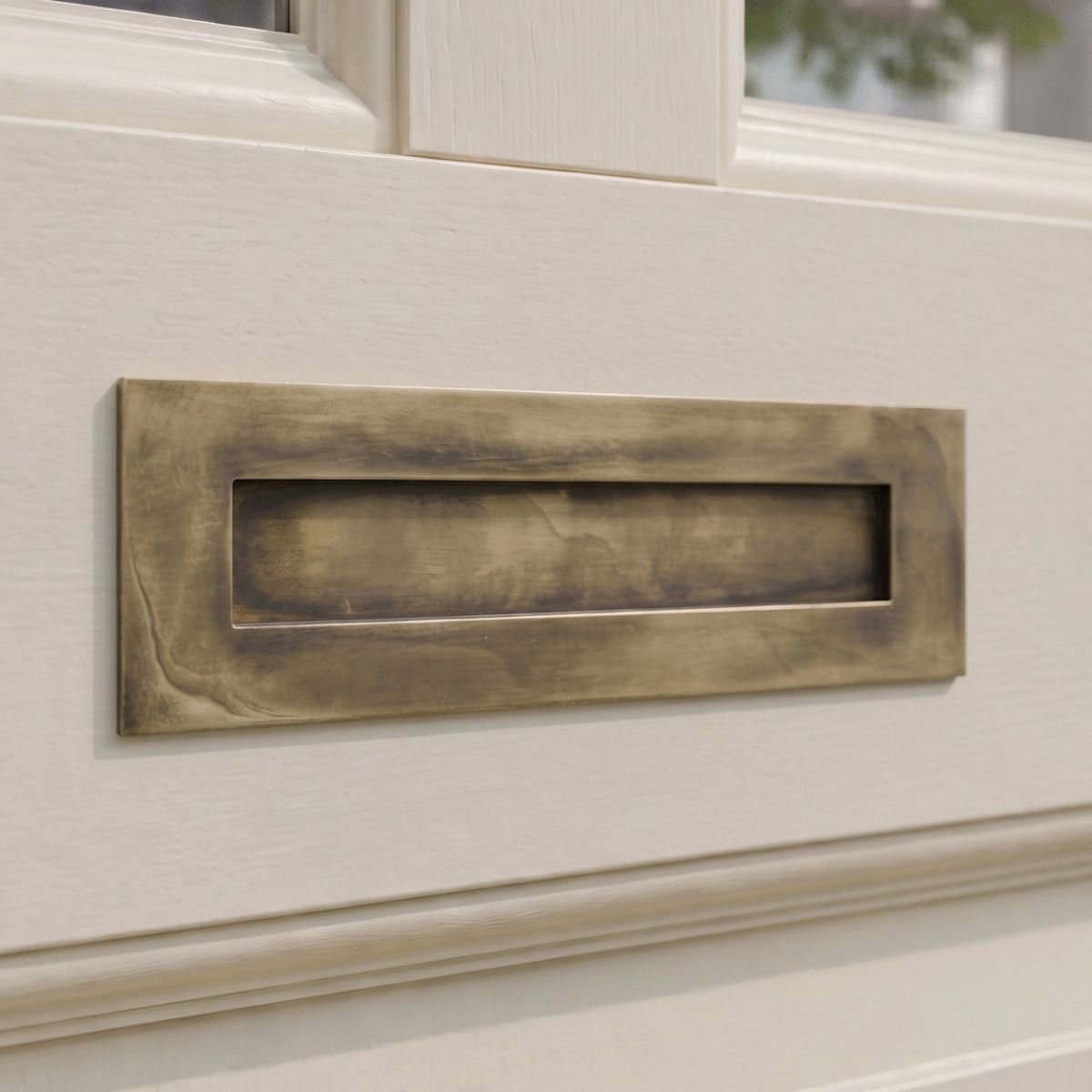 The Modern 10 Inch Front Door Letter Plate with Contemporary Minimalist Flap in Aged Brass on a Cream Coloured Front Door to a Regency Style Door - Digital Illustration