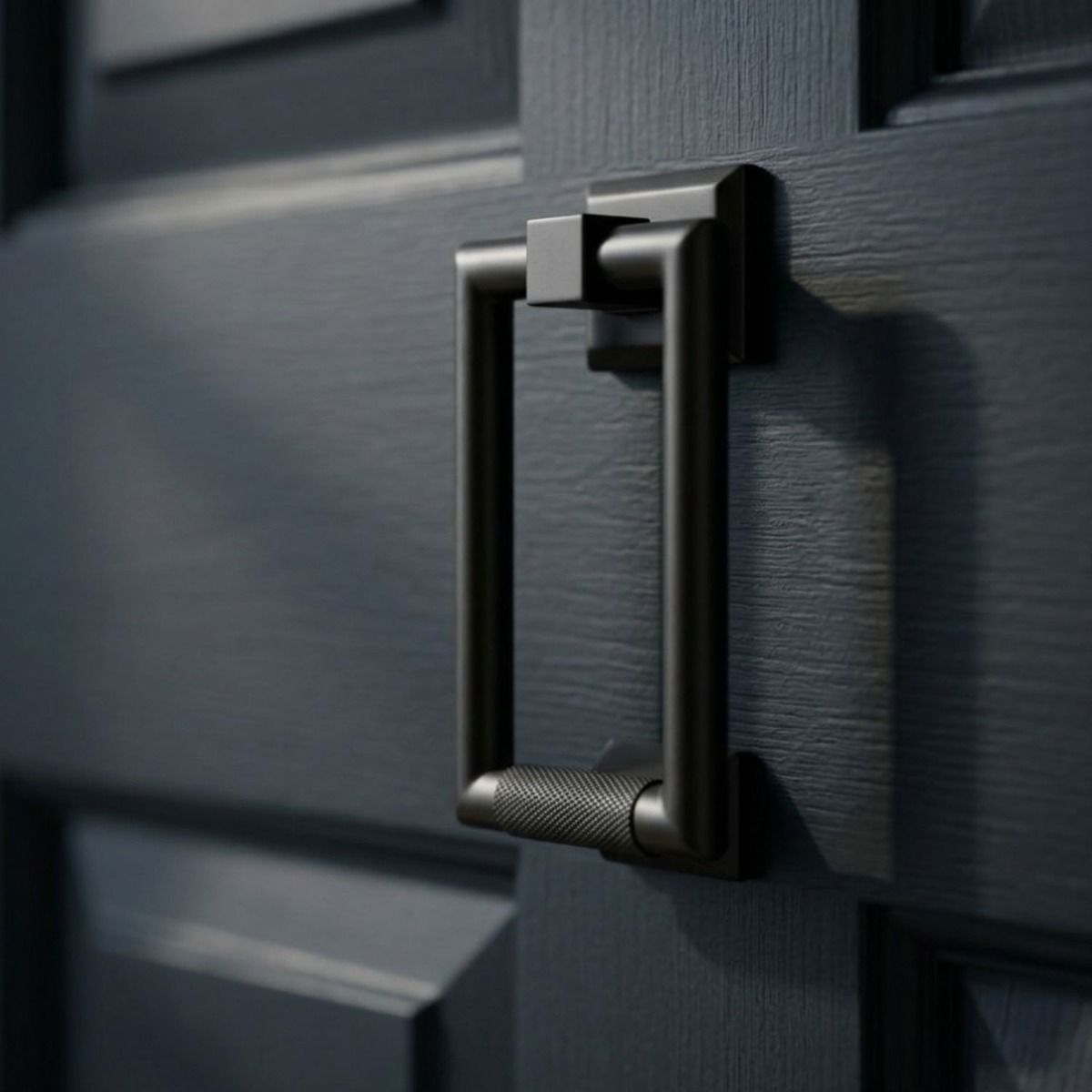 The Modern Knurled Rectangular Door Knocker  in Aged Bronze Fitted onto a Front Door thats been Painted Blue - Digital Illustration