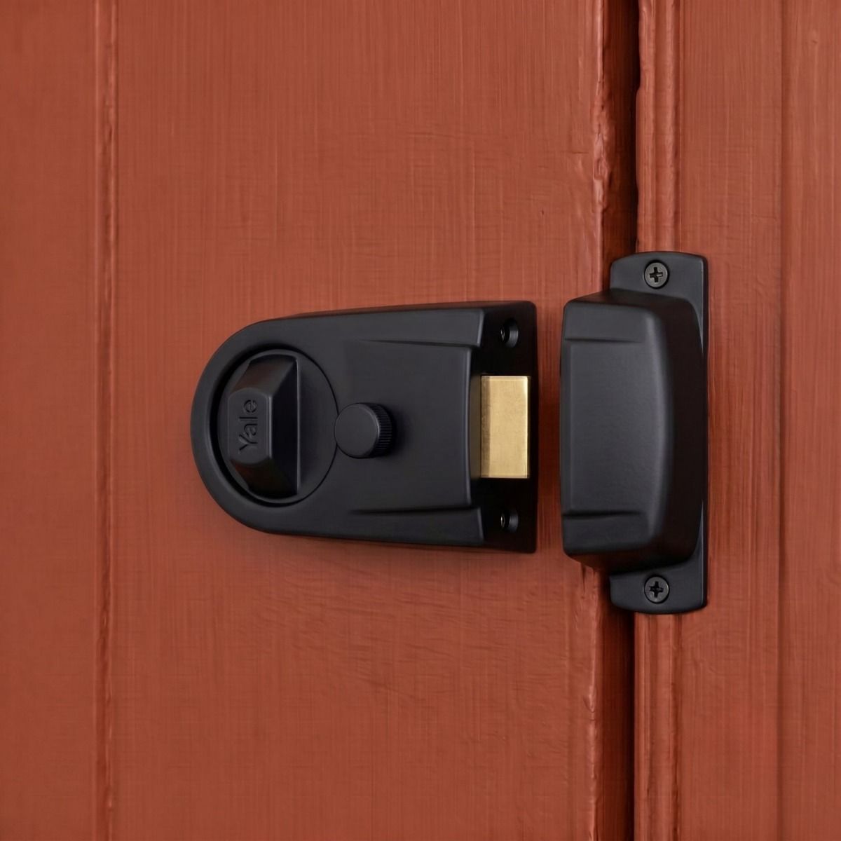 The Modern Rim Nightlatch with Cylinder Lock in a Matte black and Brass Finish Fitted on a Contemporary Wooden Door - Digital Illustration 