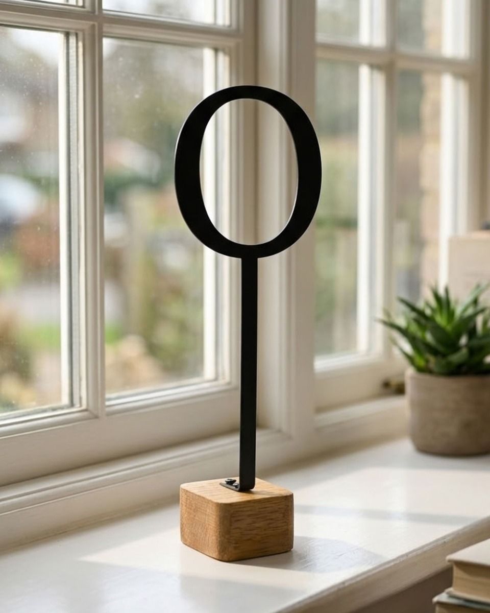 The Monograph Metal & Wood Letter Display Ornament on a Sunlit Window Sill in a Modern Home - Digital Illustration