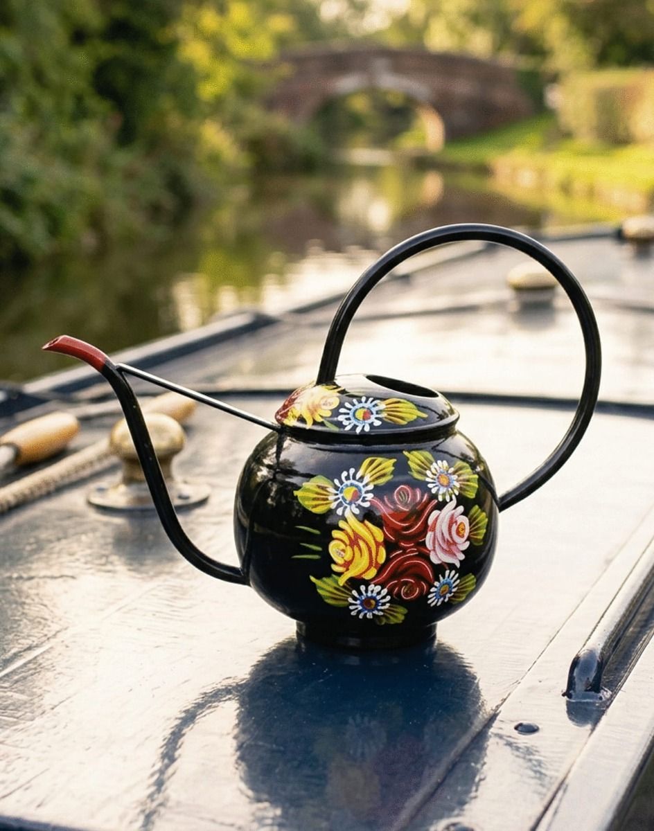 The Narrowboat Style Black Steel Watering Can Displayed on top of a Dark Blue Canal Boat in the Countryside - Digital Illustration