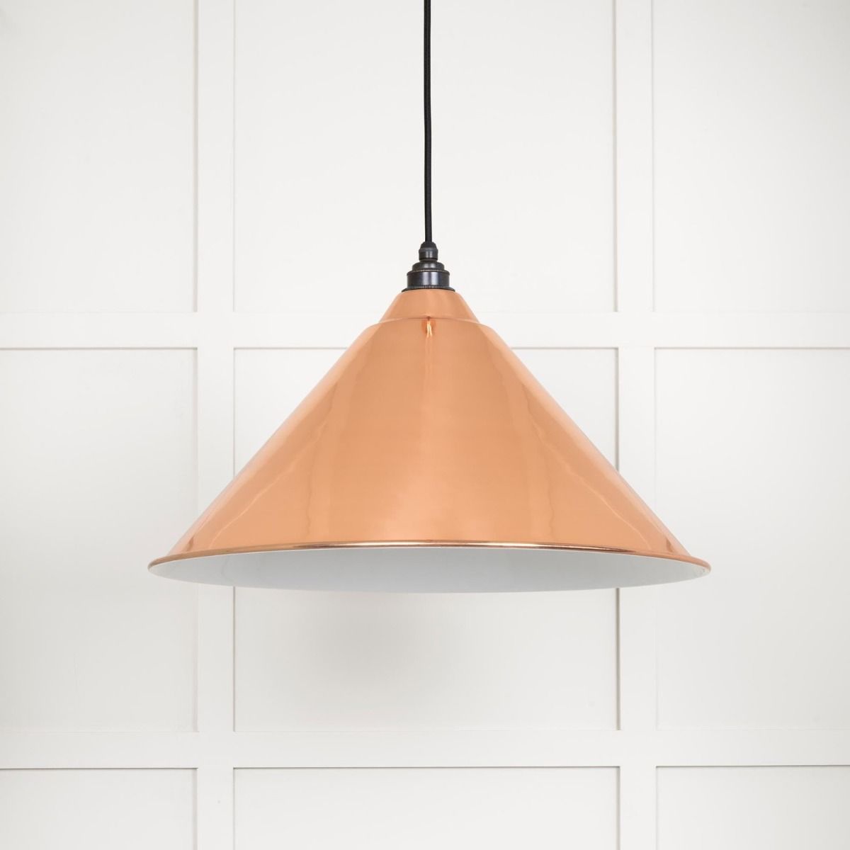 The Nidus Pendant Light in Copper and Glossy White on a White Panelled Background with Light off