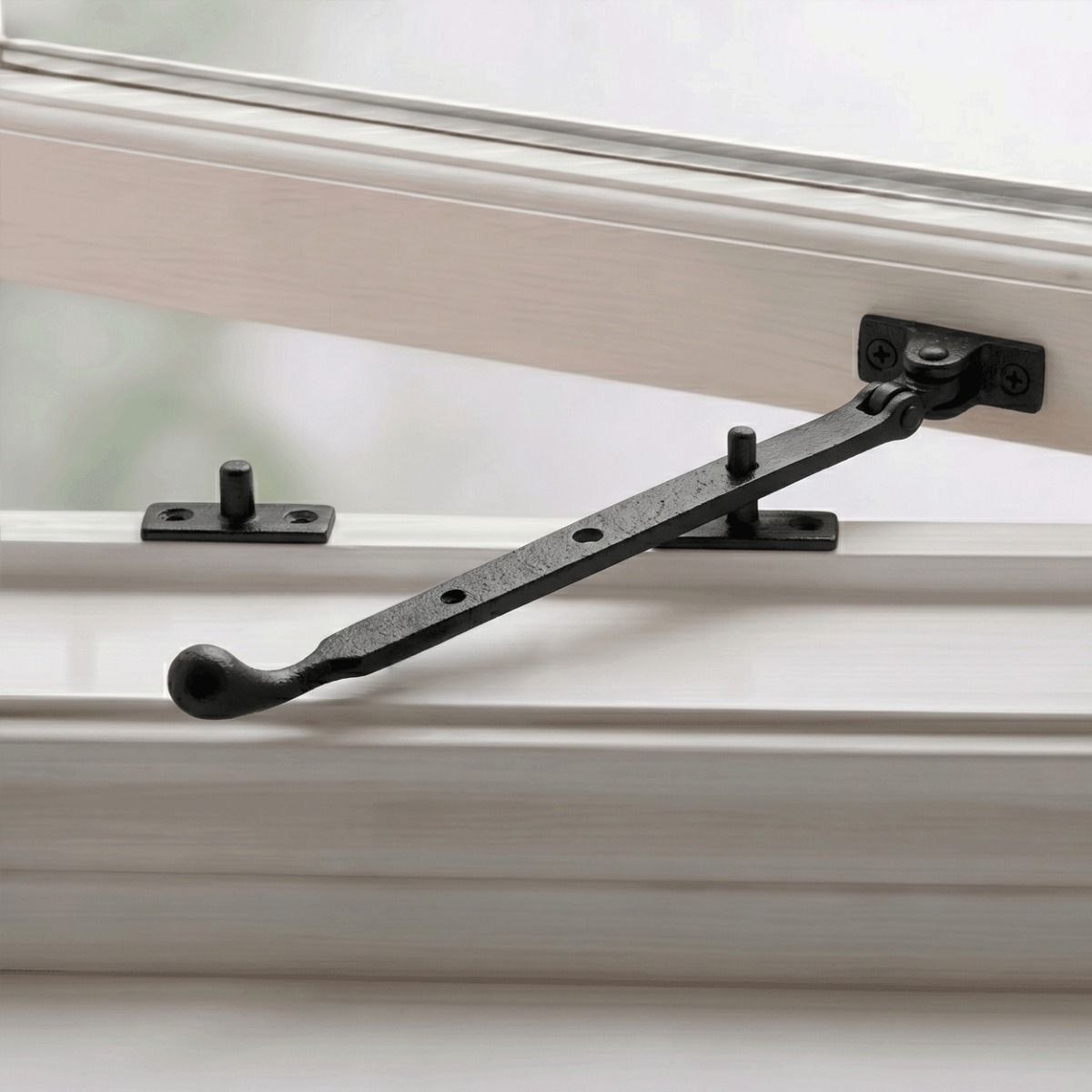 The Pear Drop End Cast Iron Window Stay Fixed on a White Wooden Window Frame - Digital Illustration 