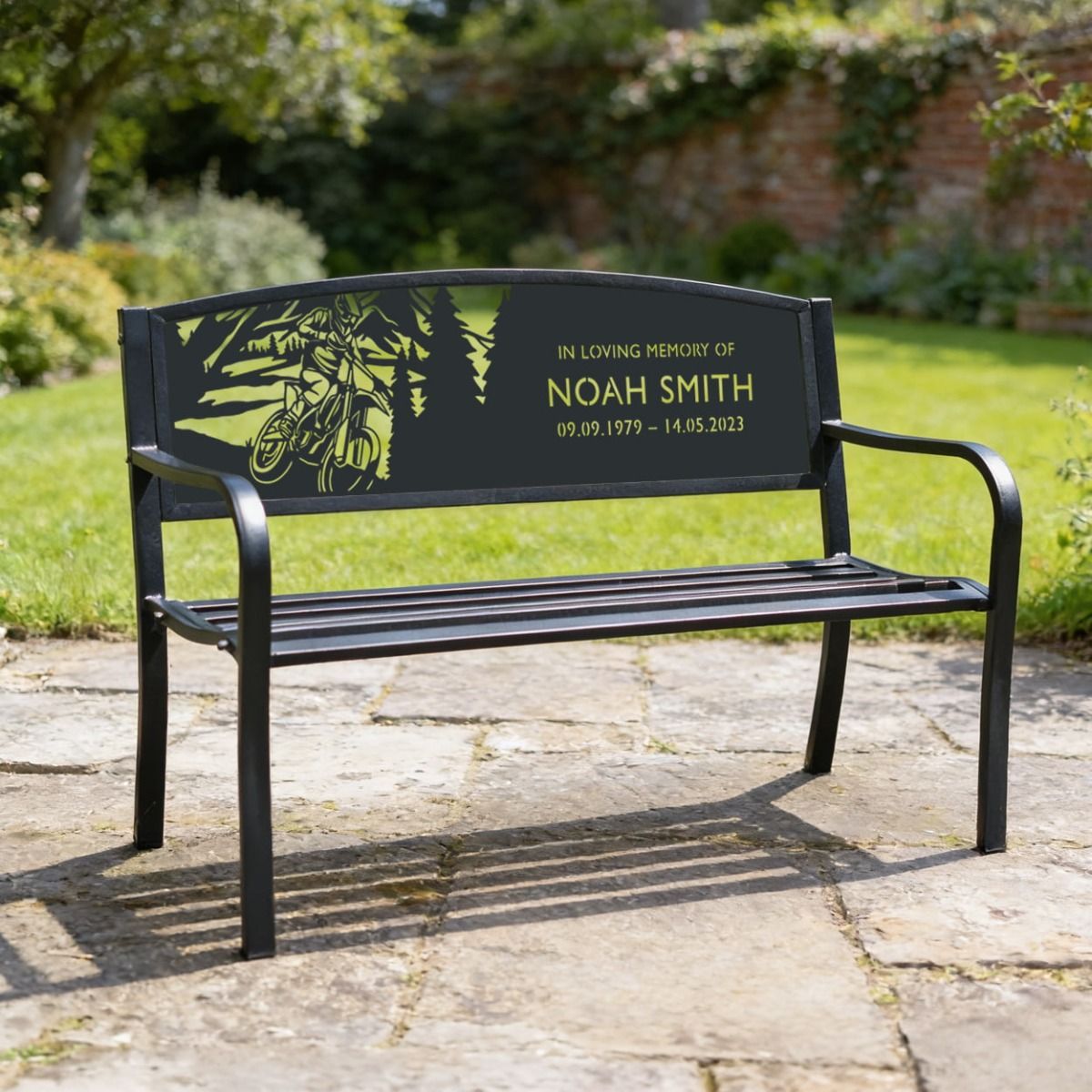 The Personalised Motocross Iron & Steel Park Bench in a Garden Used in Memory of a Loved One With Name and Dates.