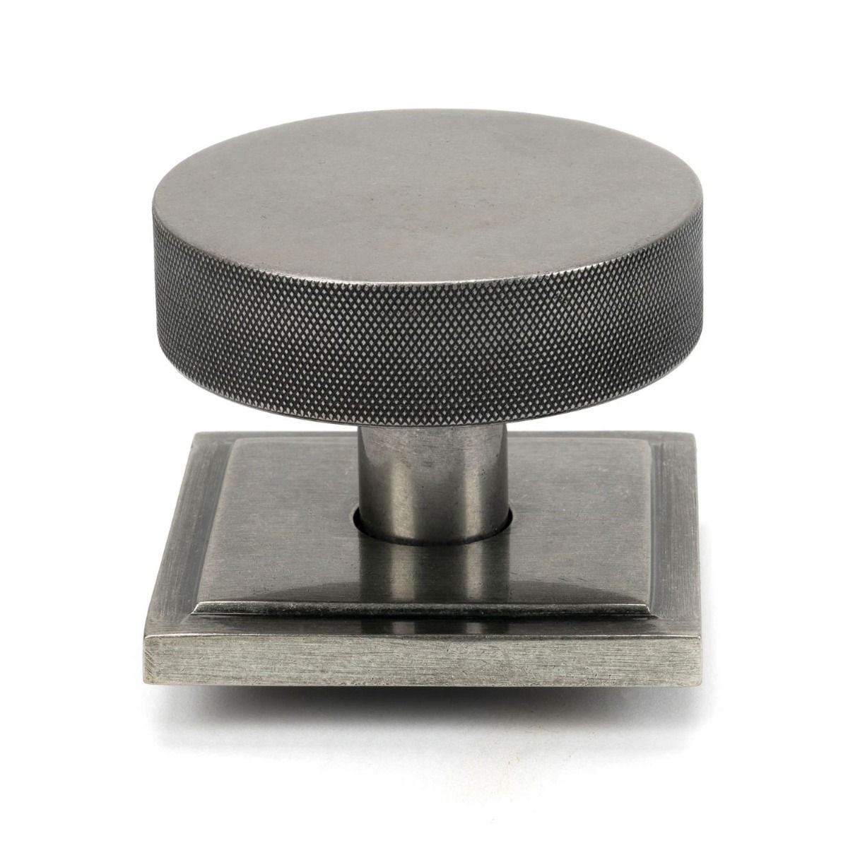 The Pewter Knurled Centre Door Knob on a Square Rose Shown Upright on a White Background 