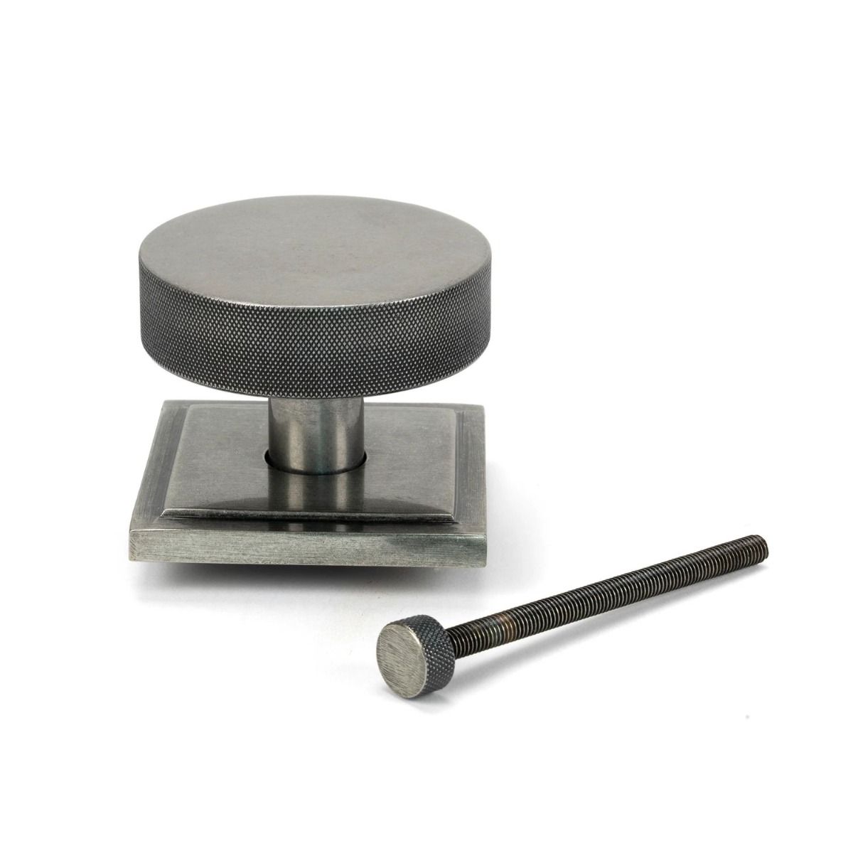 The Pewter Knurled Centre Door Knob on a Square Rose with Bolt Fitting on a White Background 
