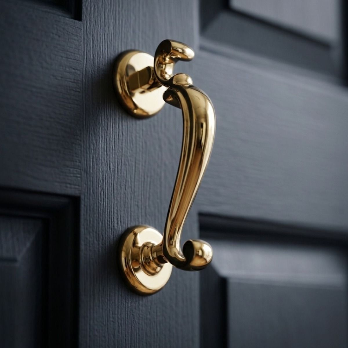 The Polished Brass "Watson" Brass Doctor"s Door Knocker on a Navy Blue Wooden Door - Digital Illustration