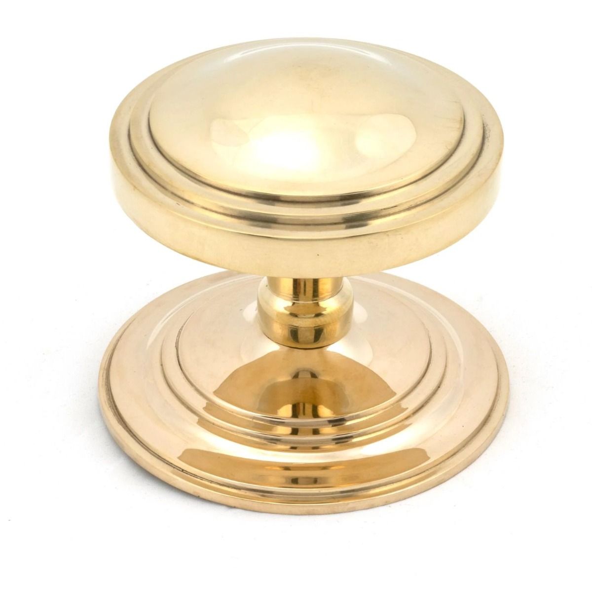 The Polished Brass Art Deco Stepped Centre Door Knob on a White Background 