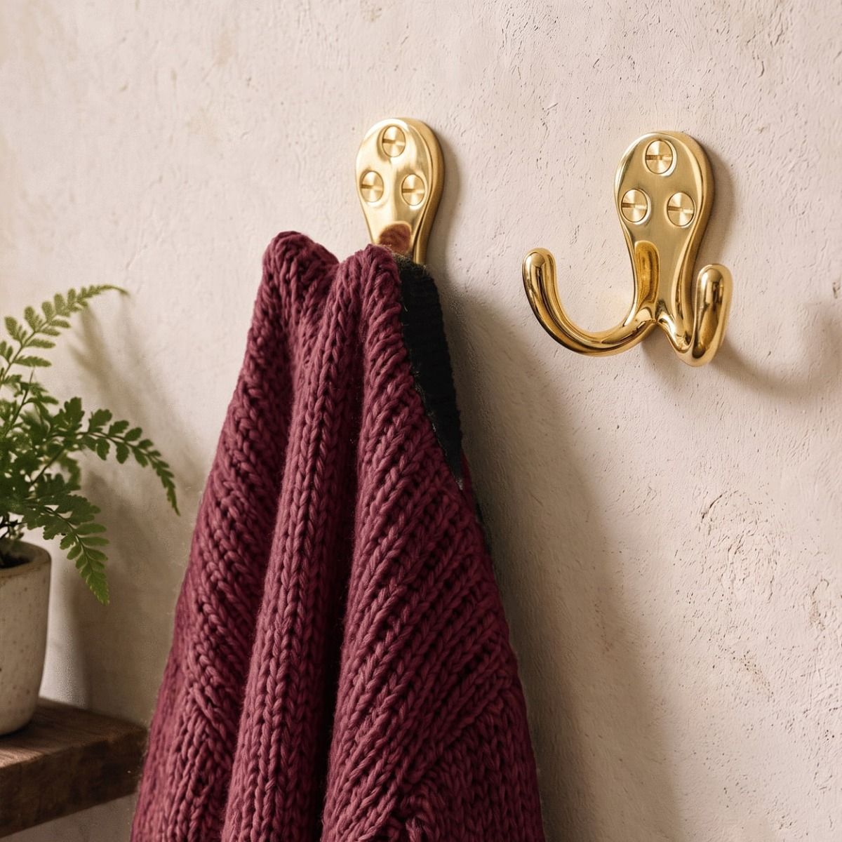 The Polished Brass Double Pronged Coat Hook Shown as a Pair With a Red Jumper Hanging From One - Digital Illustration 