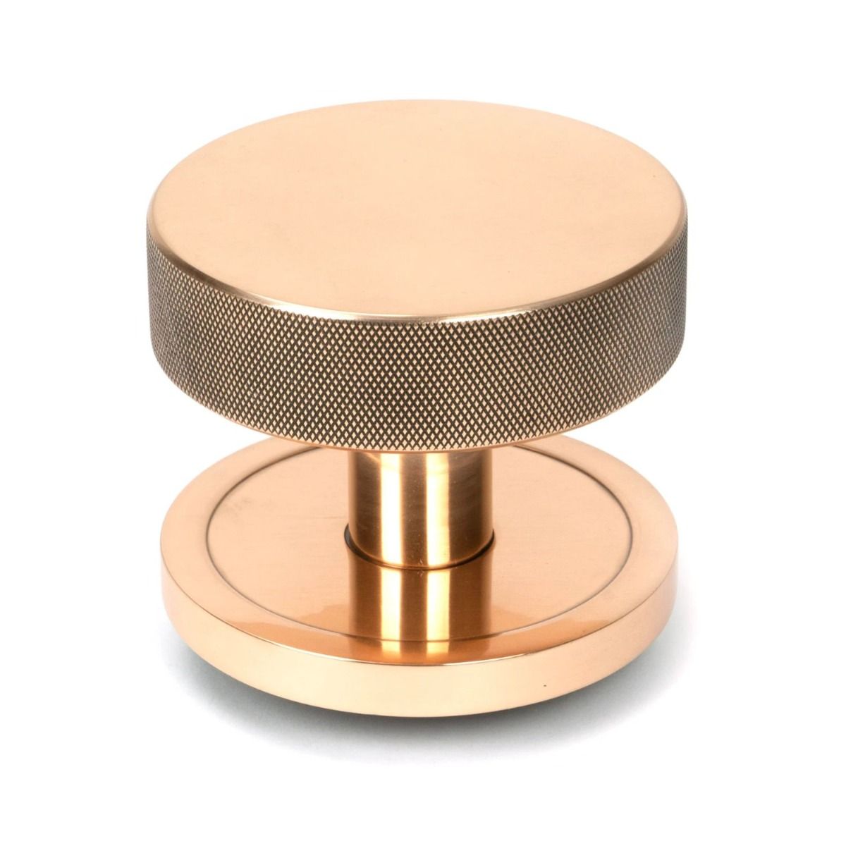 The Polished Bronze Knurled Centre Door Knob on a Plain Rose Shown Upright on a White Background 