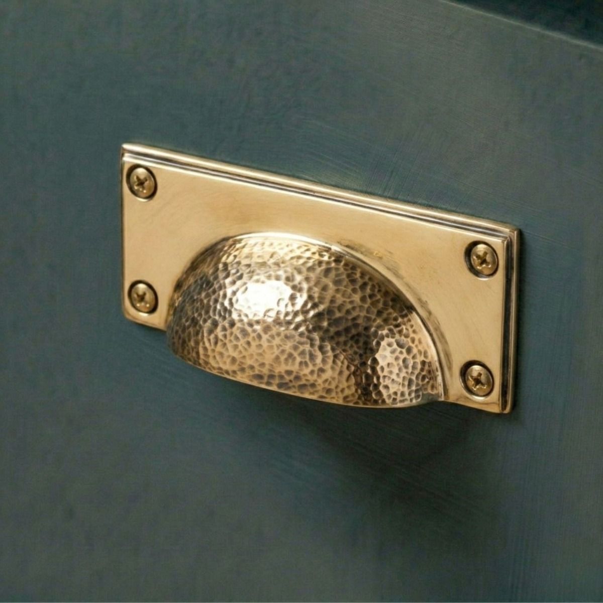 The Polished Copper Rectangular Drawer Pull with Curved Hammered Handle Mounted on a Contemporary Kitchen Cupboard Drawer - Digital Illustration