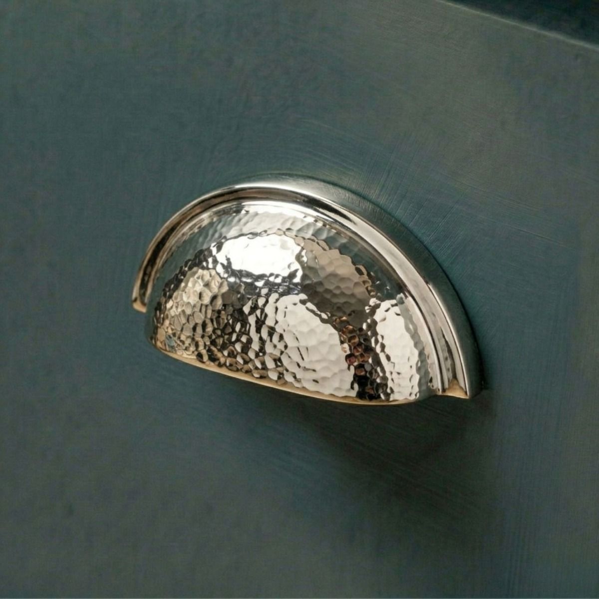 The Polished Nickel Curved Drawer Pull with Hammered Handle Fitted on a Contemporary Kitchen Cupboard Drawer - Digital Illustration 