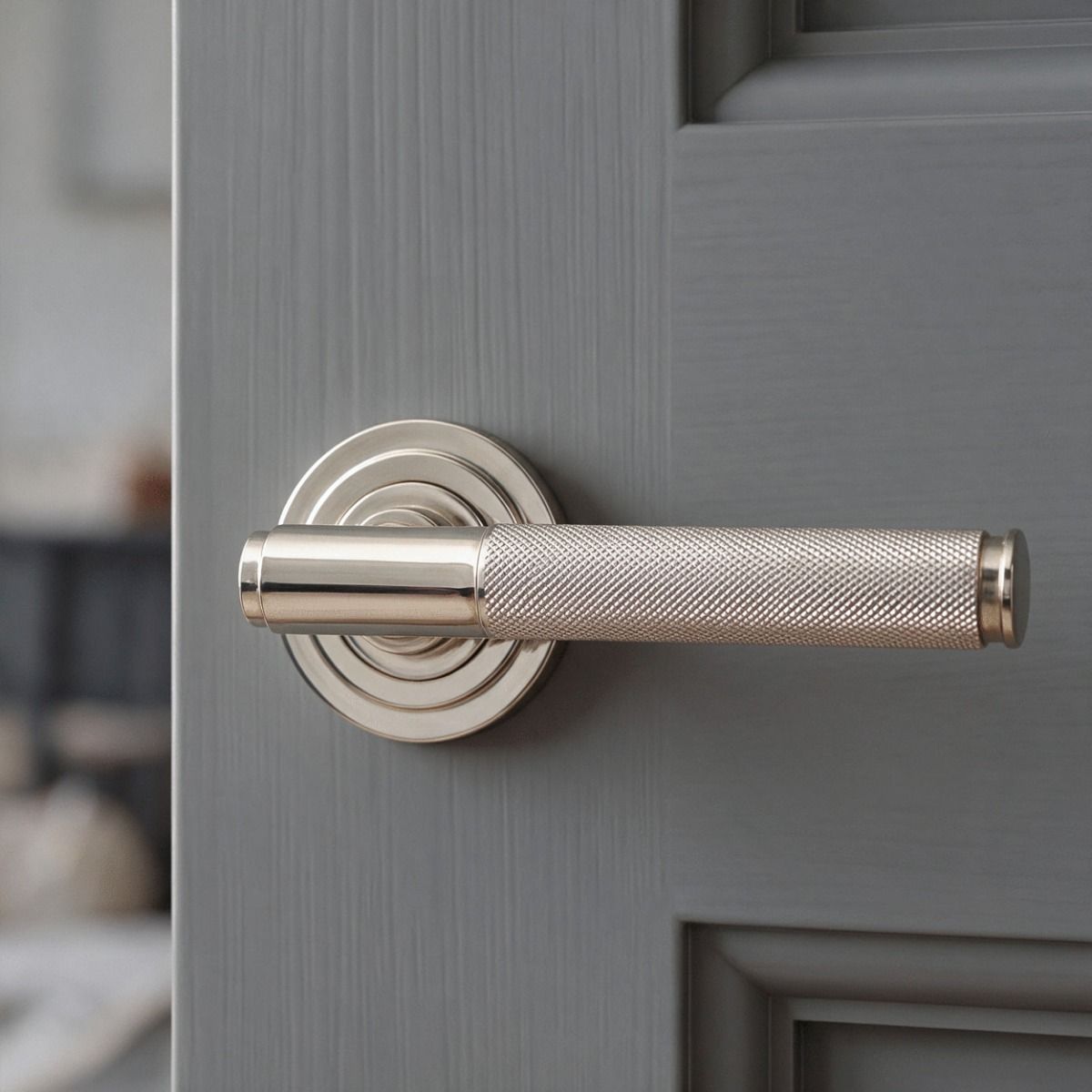 The Polished Nickel Knurled Lever on Art Deco Rose Set Shown Close up on a Light Grey Door - Digital Illustration 