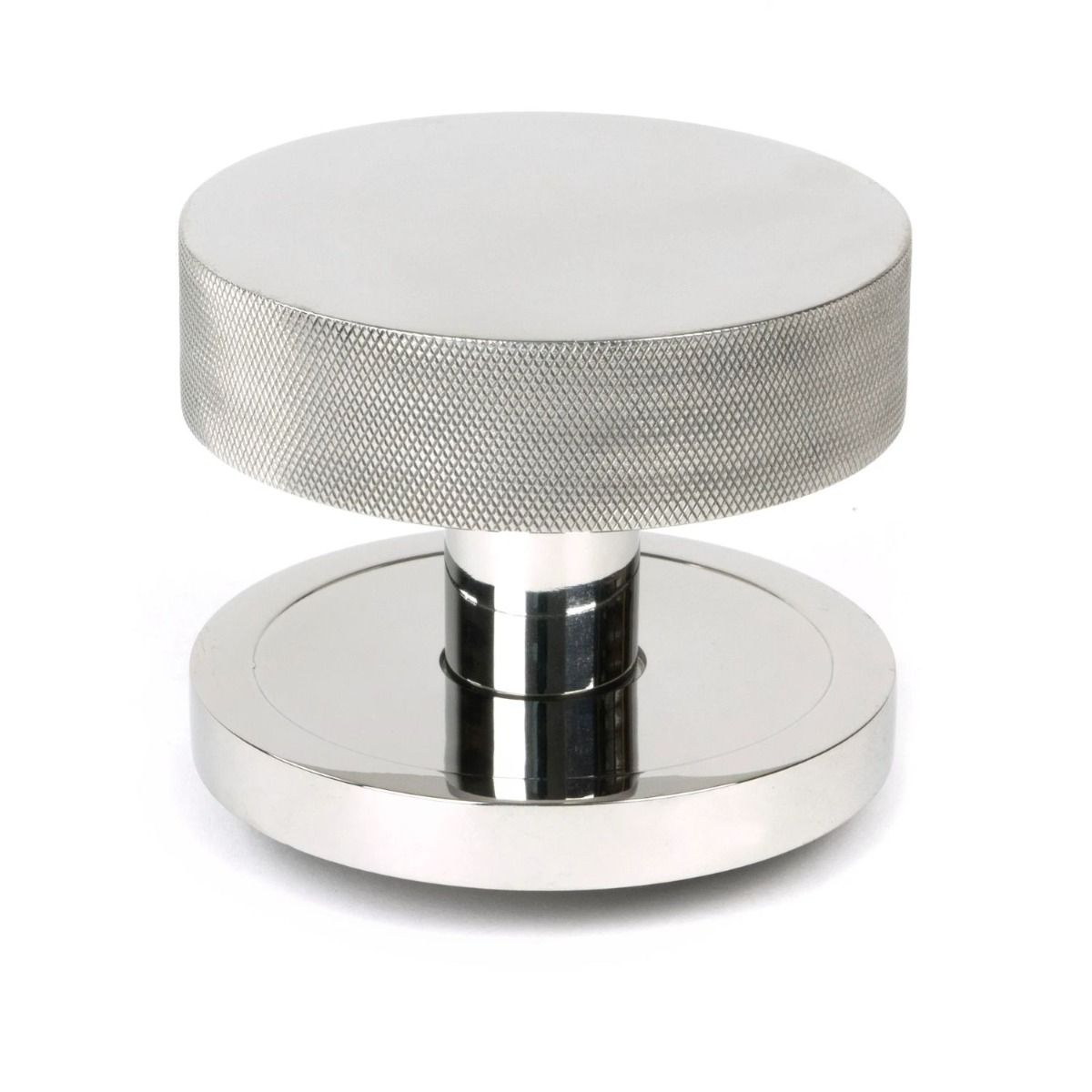 The Polished Stainless Steel Knurled Centre Door Knob on a Plain Rose Shown Upright on a White Background 