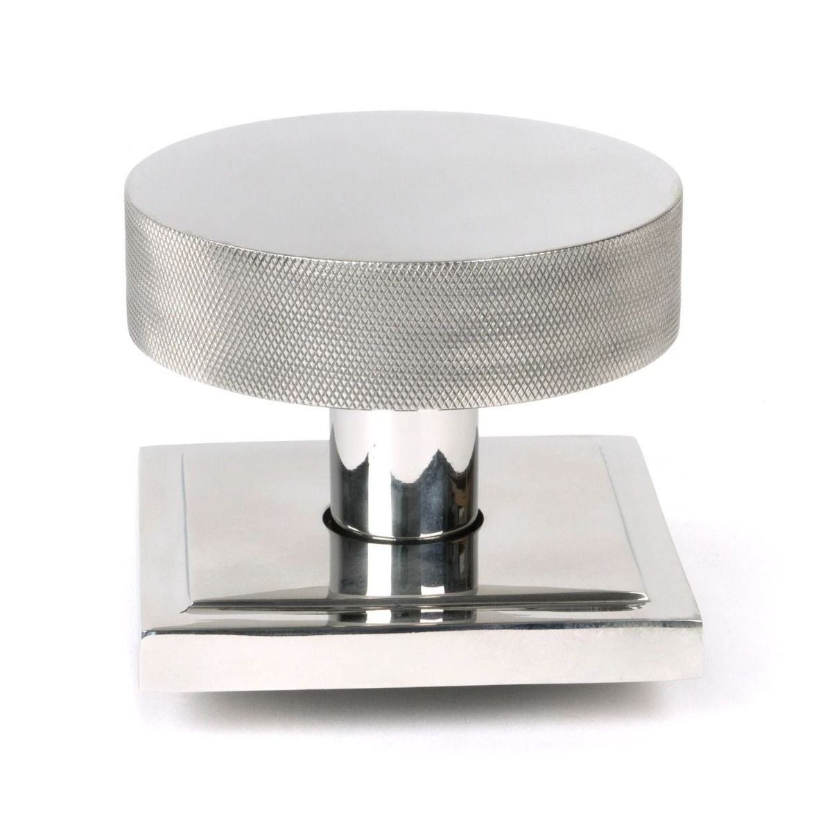 The Polished Stainless Steel Knurled Centre Door Knob on a Square Rose Shown Upright on a White Background 