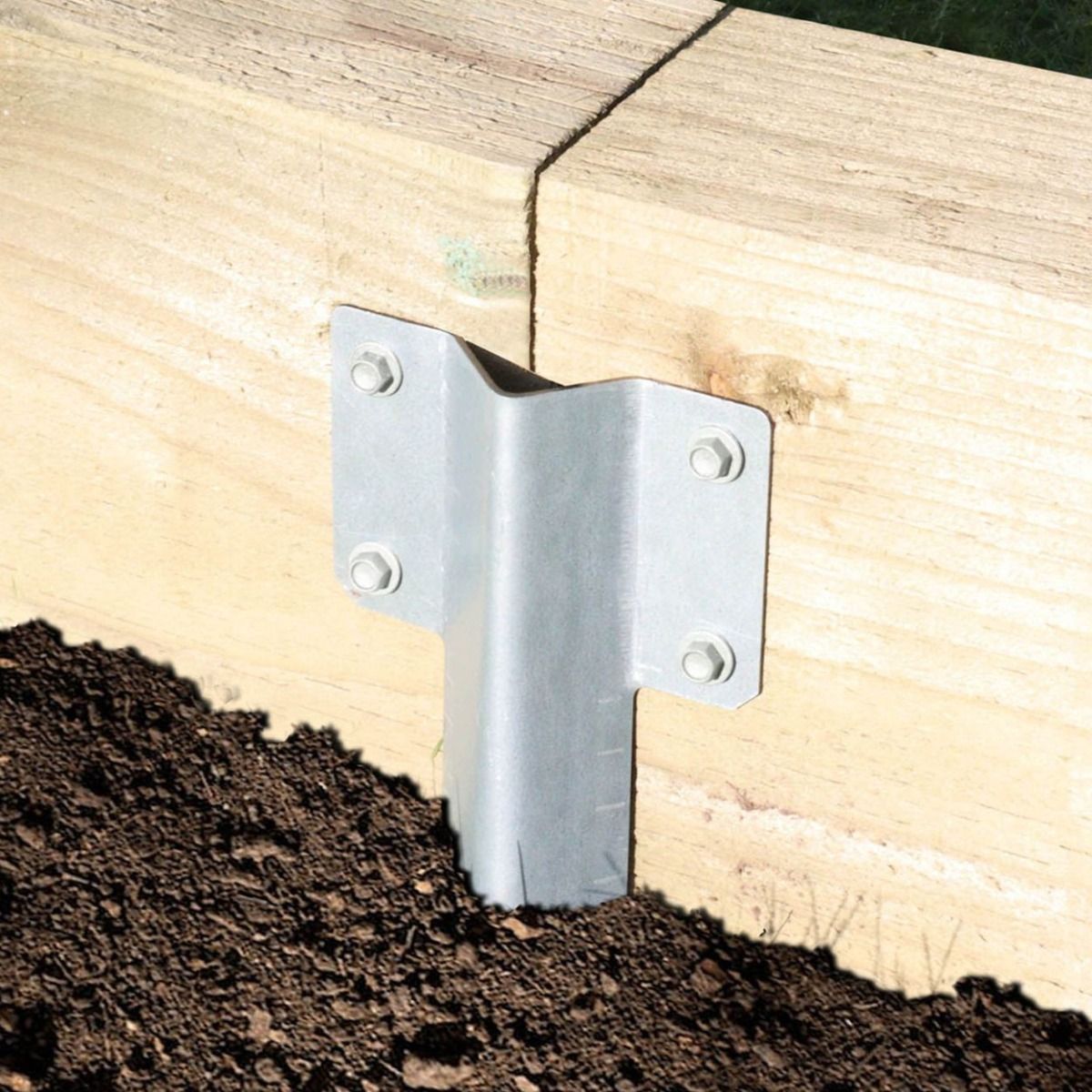 The Pregalvanised Railway Sleeper Straight Inline Spikes - Single in the Ground next to a Railway Sleeper Planter