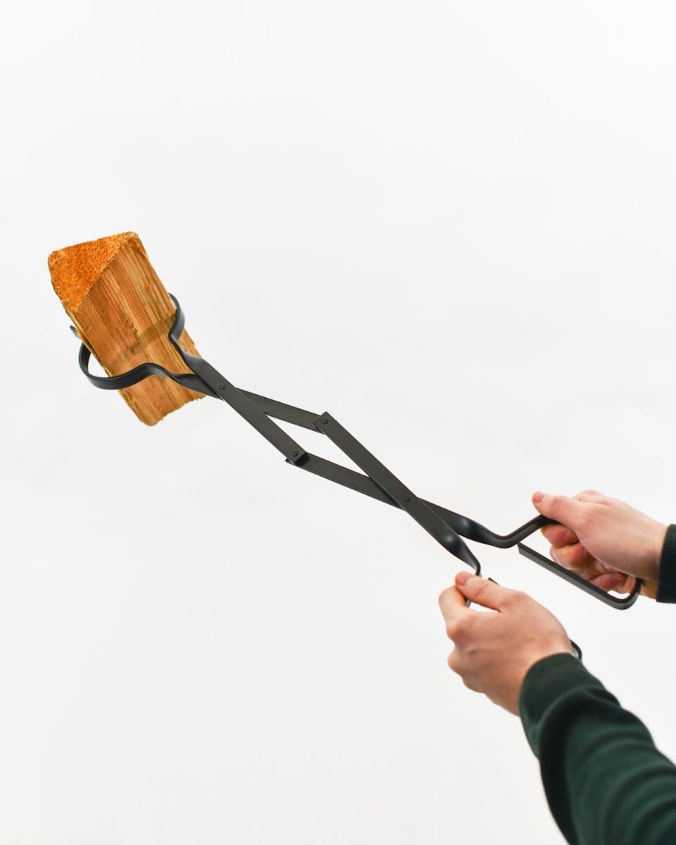 The “Prism” Steel Fire Place Tongs holding log at angle