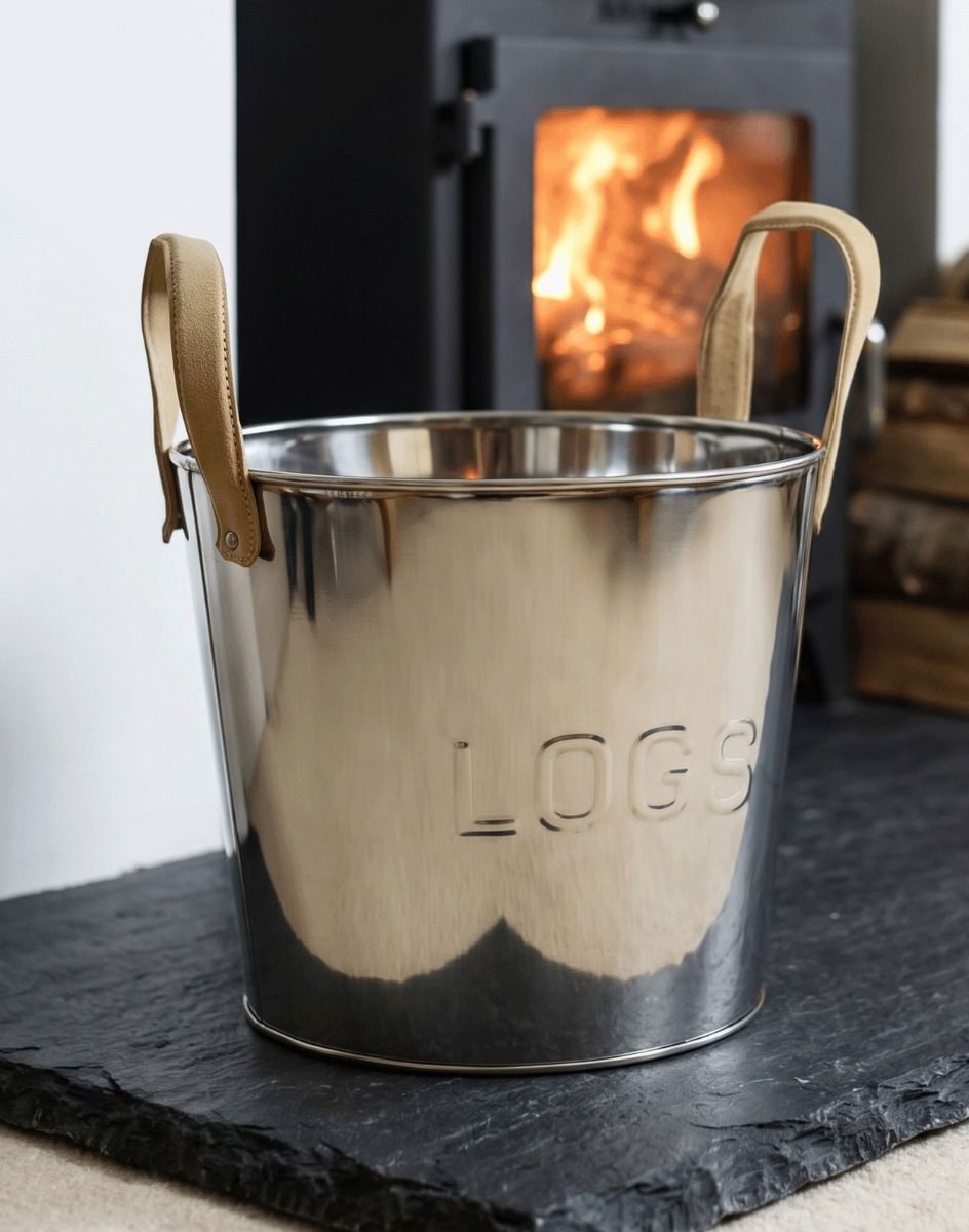 The “Radcliffe Hall” Stainless Steel Log Basket in a White Living Room Next to a Glowing Log Burner - Digital Illustration