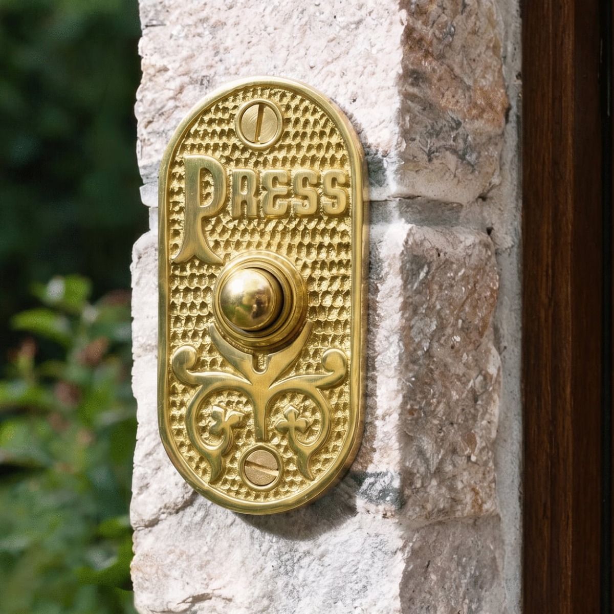 The "Ribbey Hall" Polished Brass Brass Bell Push Fitted next to a Door on a Stone Wall - Digital Illustration