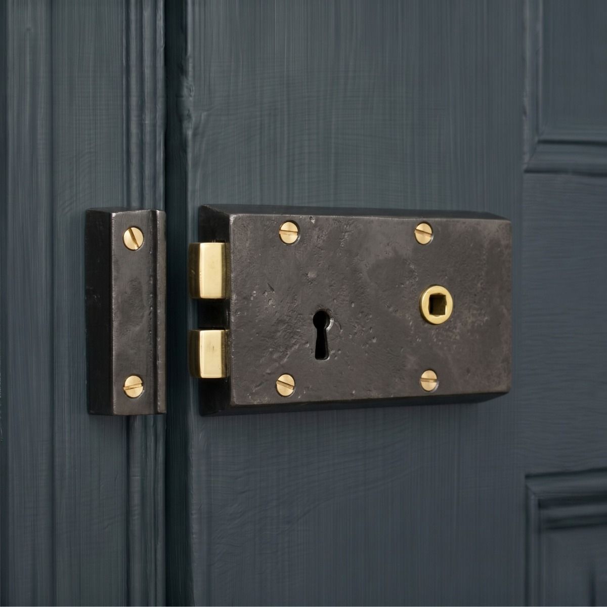The Right Handed "Hartwin" Small Iron Rim Lock Mounted on a Wooden Blue Home Entrance - Digital Illustration