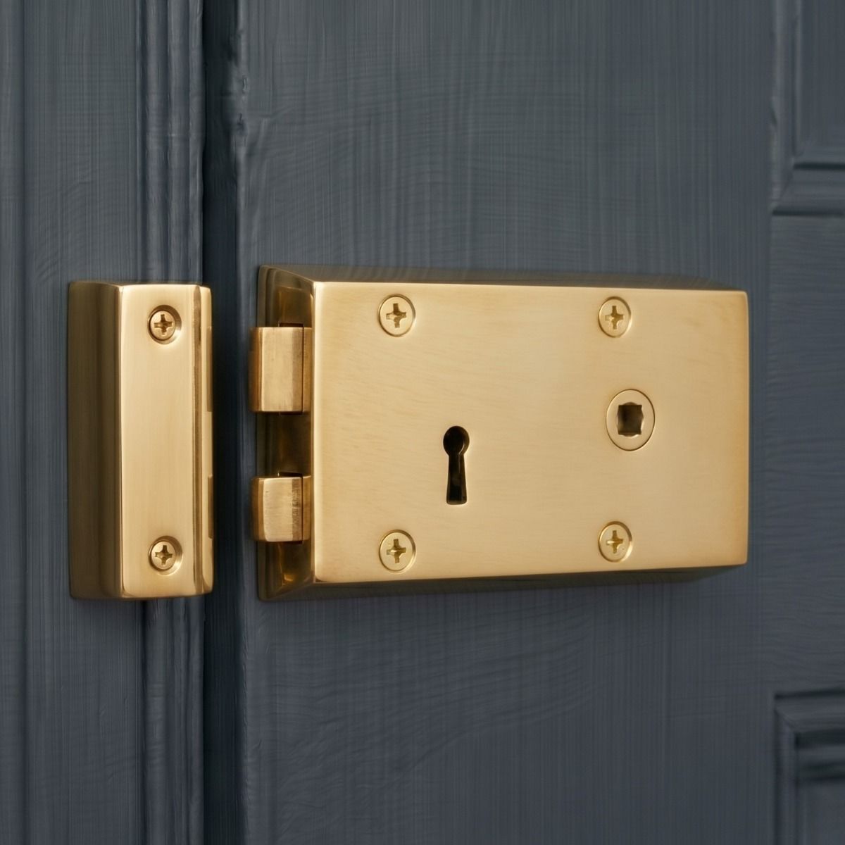 The Right Handed "Lombardy" Large Polished Brass Rim Lock on a Blue Wooden Door - Digital Illustration