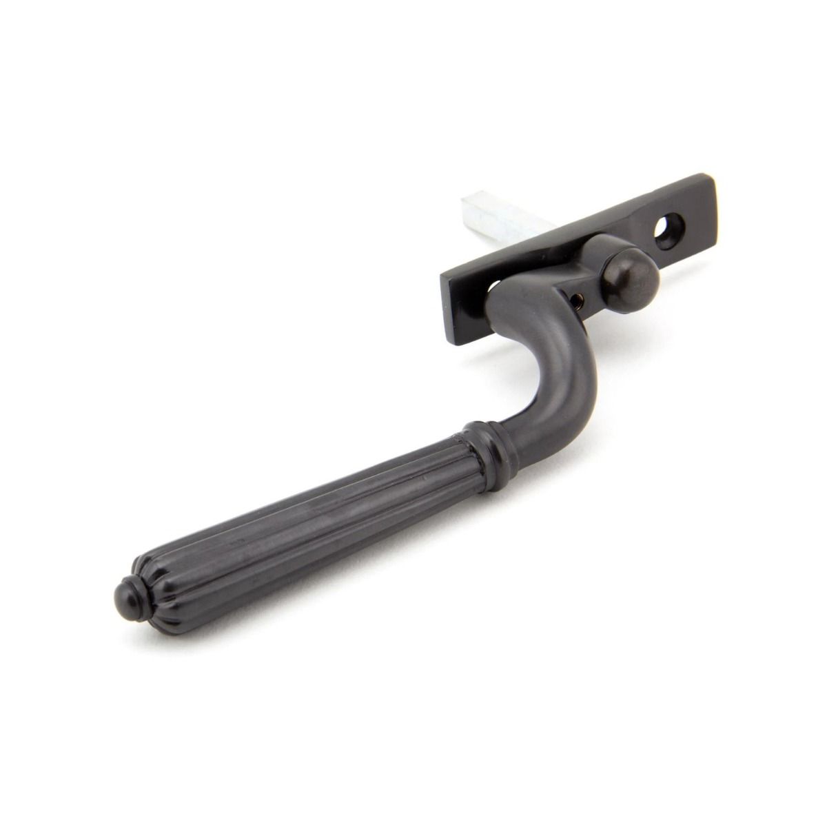 The Right Handed Aged Bronze Reeded Georgian Espagnolette Window Handle on a White Background Shown on its Side 