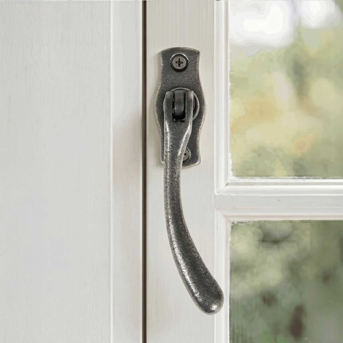The Right Handed Antique Pewter Peardrop Window Handle Mounted on a Traditional White Window Frame - Digital Illustration 