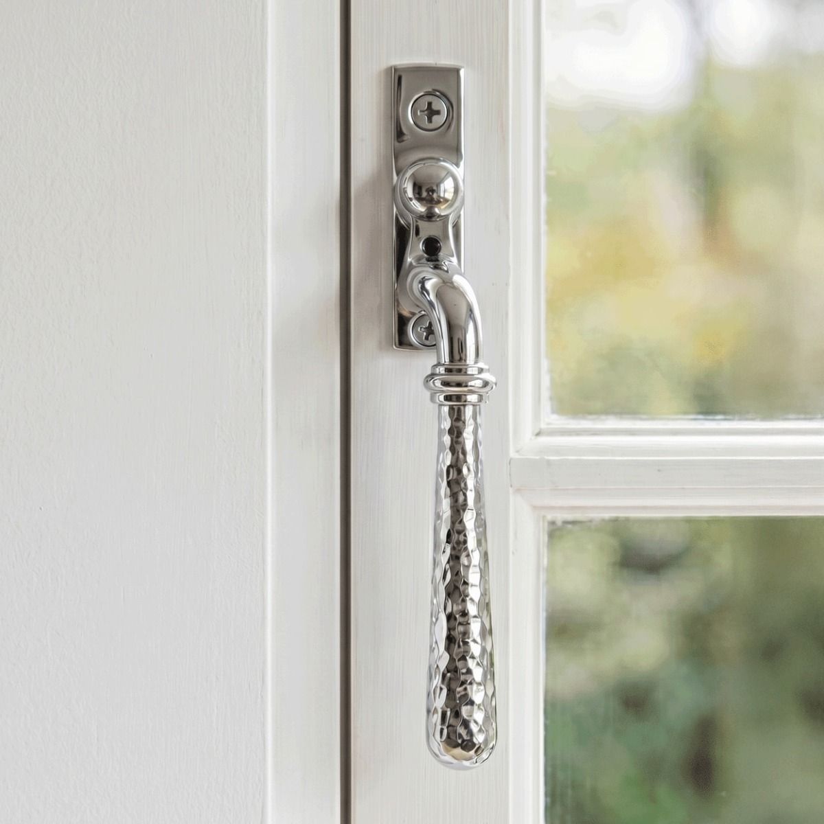 The Right Handed Bright Chrome Hammered Espag Window Handle Mounted on a Classic White Wooden Window Frame - Digital Illustration 
