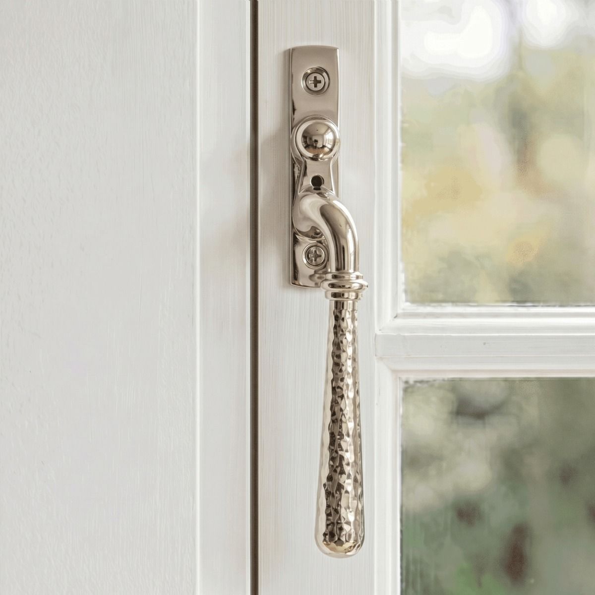 The Right Handed Polished Nickel Hammered Espag Window Handle Fixed on a Painted White Window Frame - Digital Illustration 