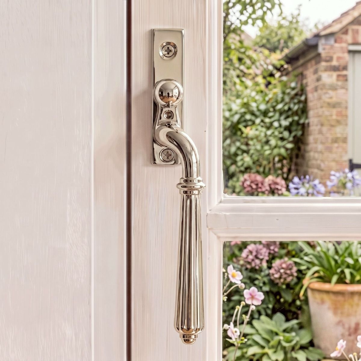 The Right Handed Polished Nickel Reeded Georgian Espagnolette Window Handle on a White Wooden Window Frame in a Country Home- Digital Illustration