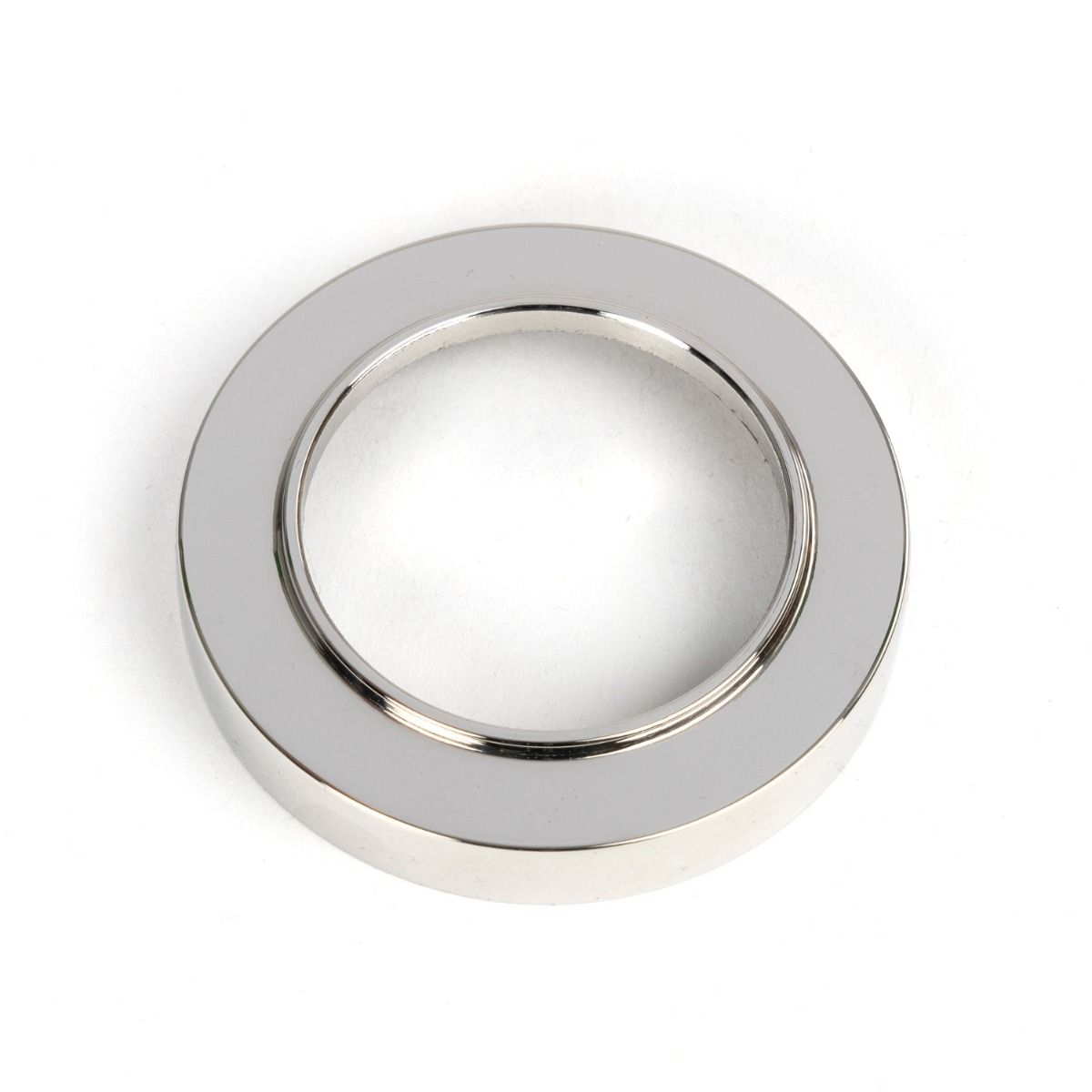 The Round Concealed Standard Keyhole Escutcheon in Polished Stainless Steel Showing Just the Backplate on a White Background
