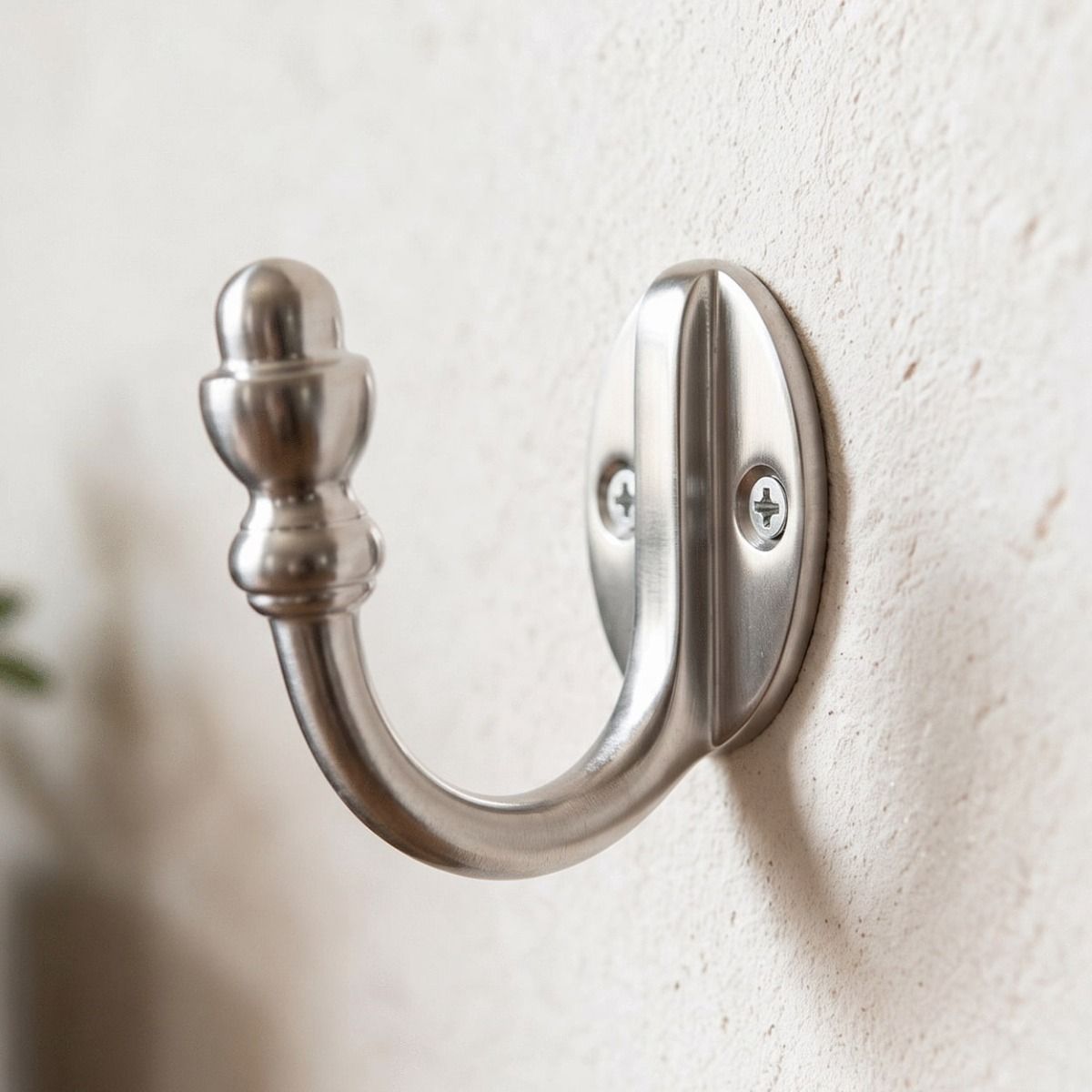 The Satin Chrome Single Pronged Mushroom-Capped Coat Hook Shown Cole Up on a White Wall - Digital Illustration 