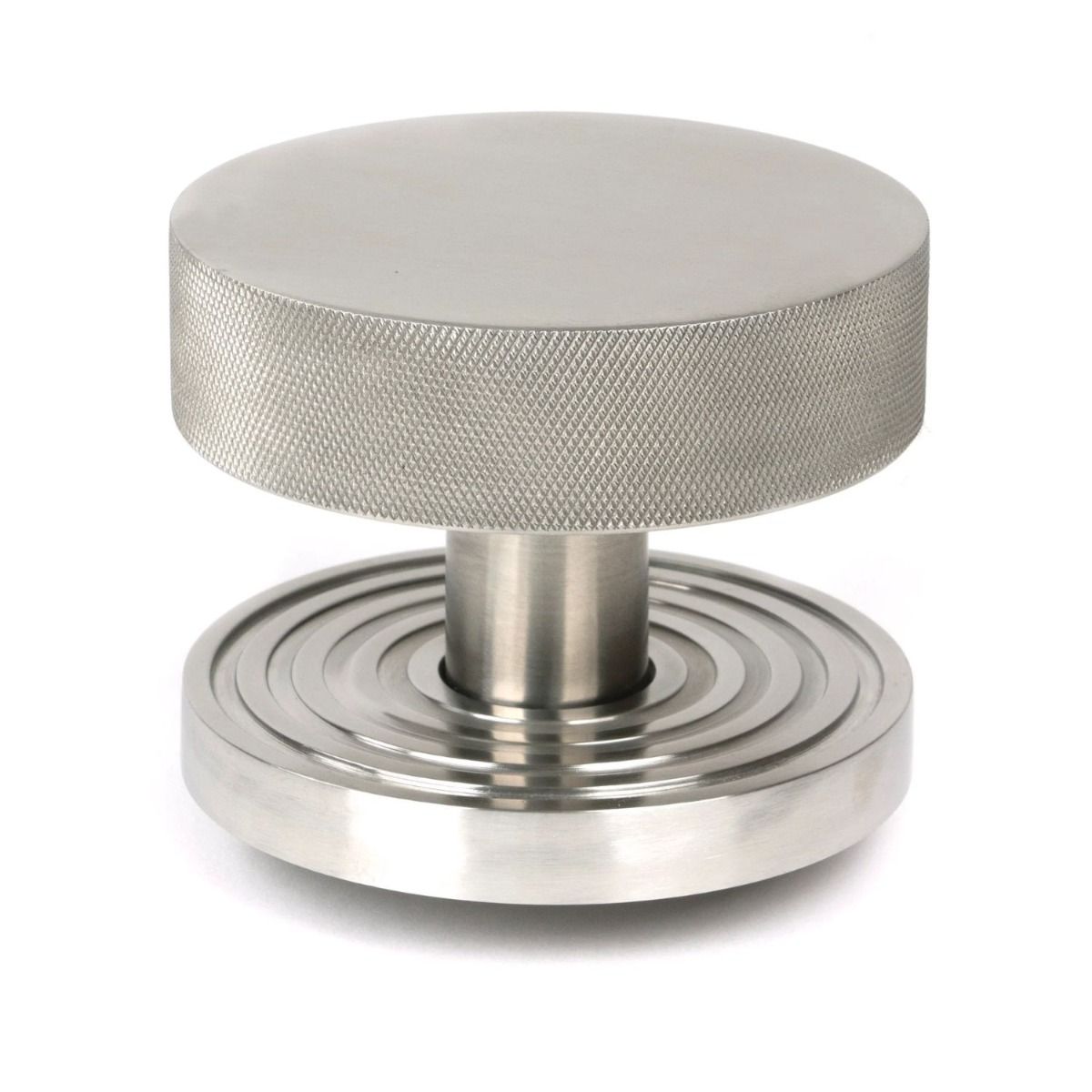 The Satin Stainless Steel Knurled Centre Door Knob on a Beehive Rose Shown Upright on a White Background 