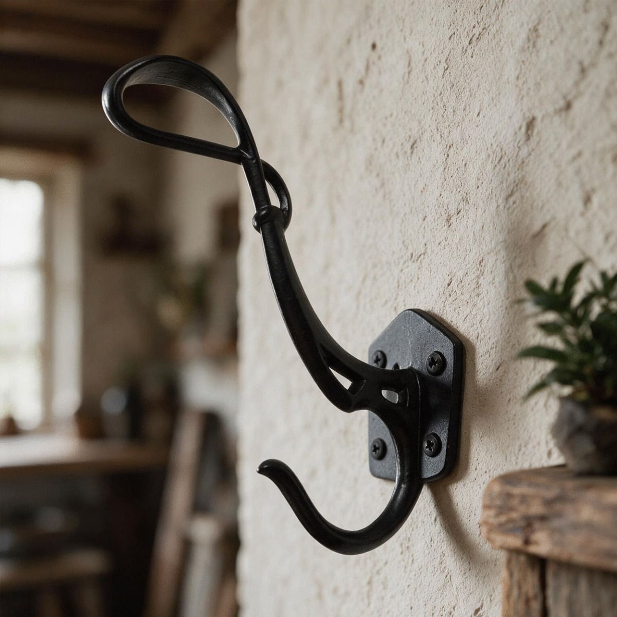 The "Schubert" Iron Coat Hook Shown Mounted on a Wall in a Traditional Home - Digital Illustration