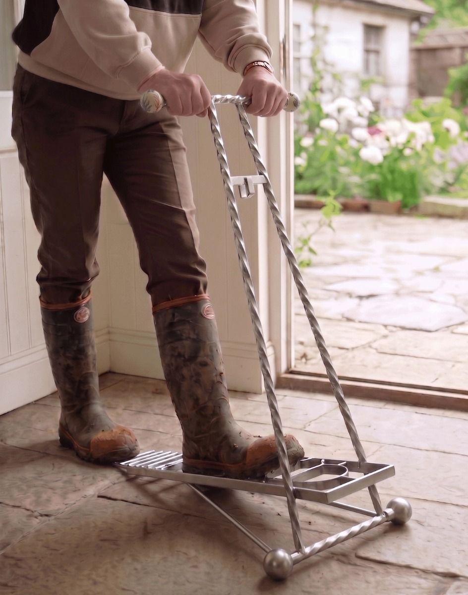 The Silver Glenmore Boot Jack Shown Being Used in a Traditional Cottage Porch Entrance - Digital Illustration 