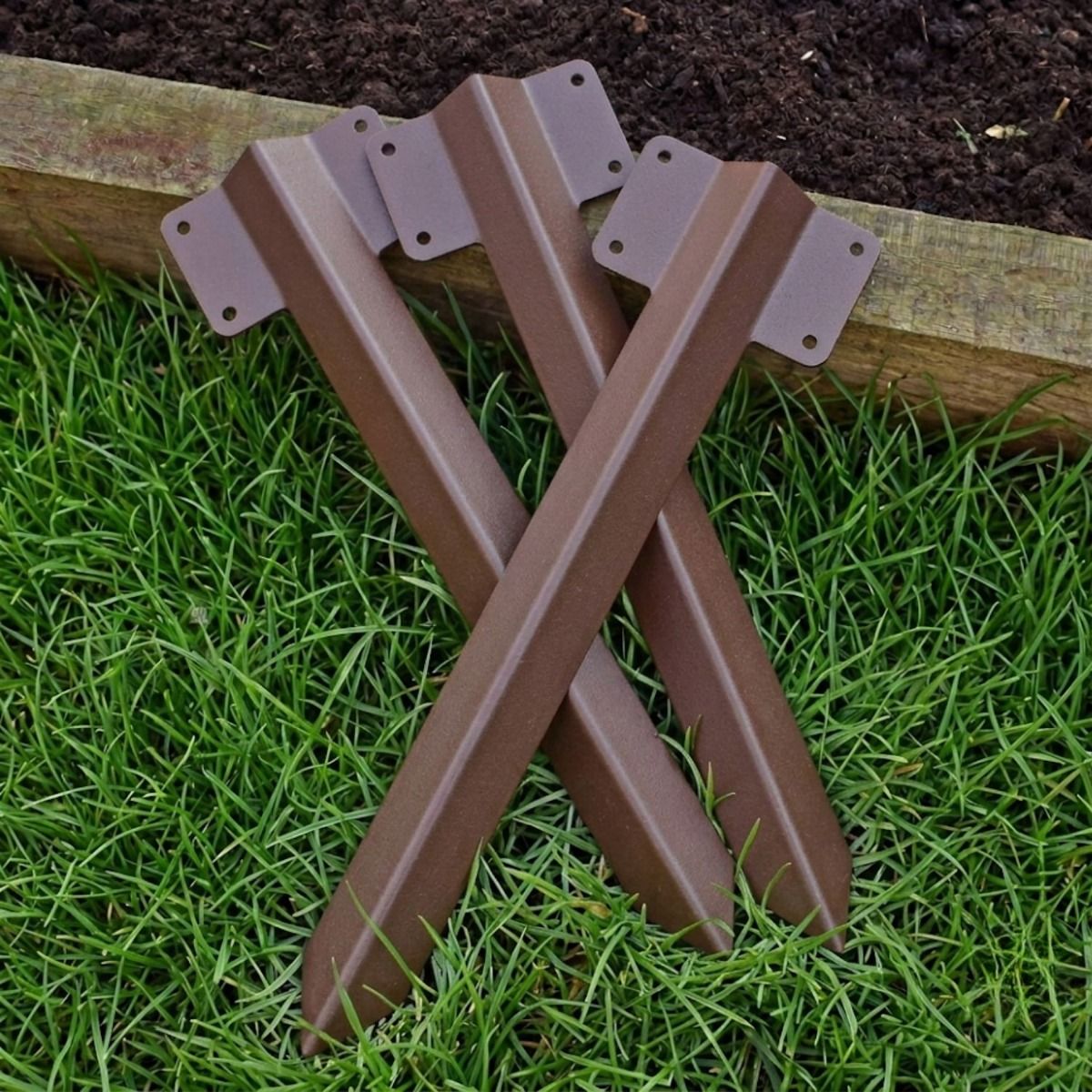 The Single Brown Railway Sleeper Straight Inline Spikes in Brown next to a Raised Flower Bed.