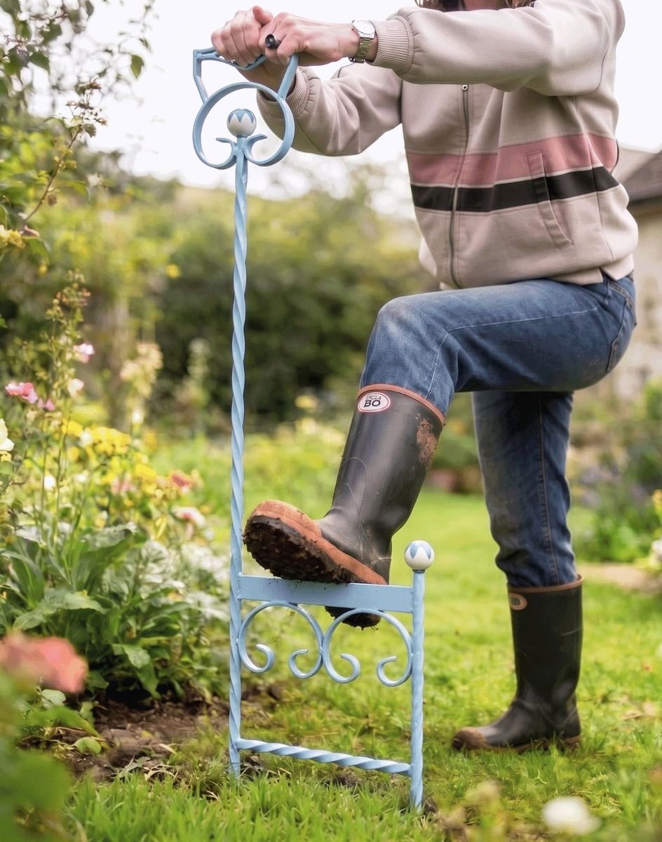The Sky Blue Boot Scraper Pictured Being Used Next to a Garden Flower Border - Digital Illustration