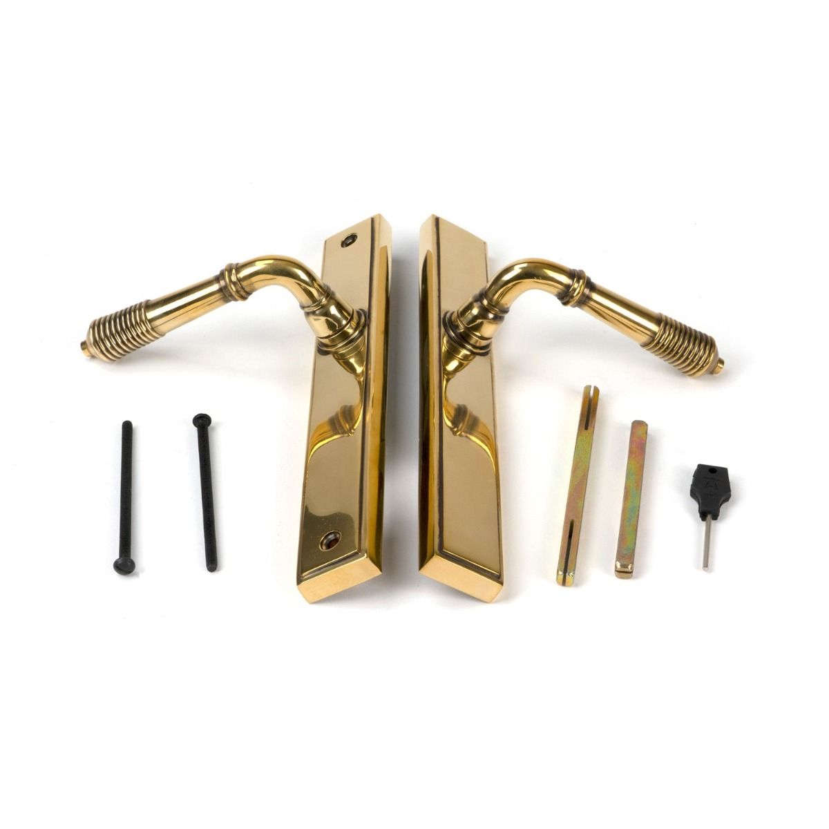 The Slimline Lever Espagnolette Door Latch in Aged Brass Laid out with all Supplied Components