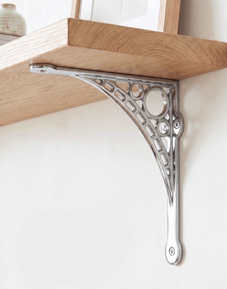 The Small 20cm x 22cm Bright Chrome "Iron Bridge" Shelf Bracket Mounted on a Plain white Interior Living Room Wall - Digital Illustration