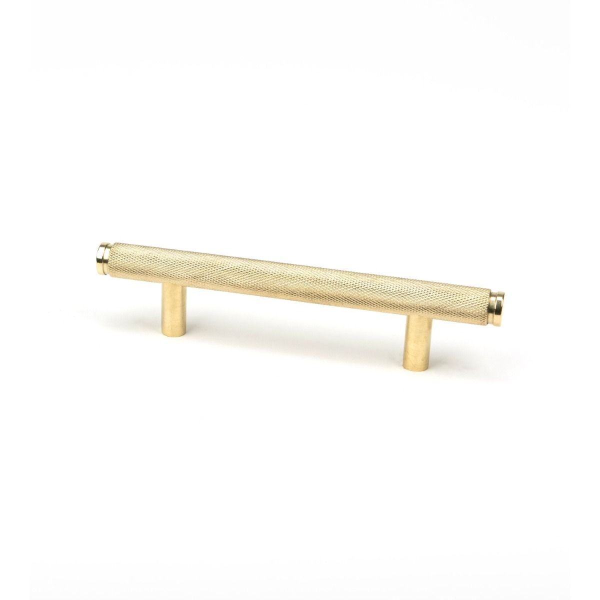 The Small Knurled Cabinet Pull Handle in Polished Brass Shown Upright on a White Background