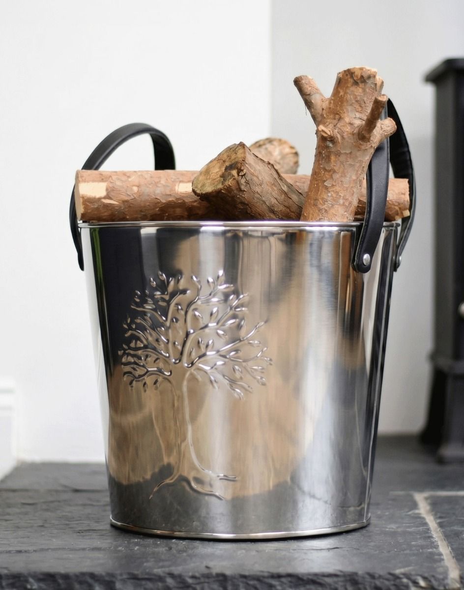 The Small Polished Steel "Tree of Life" Log Bucket on a Stone Hearth next to a Log Burner Stove - Digital Illustration 