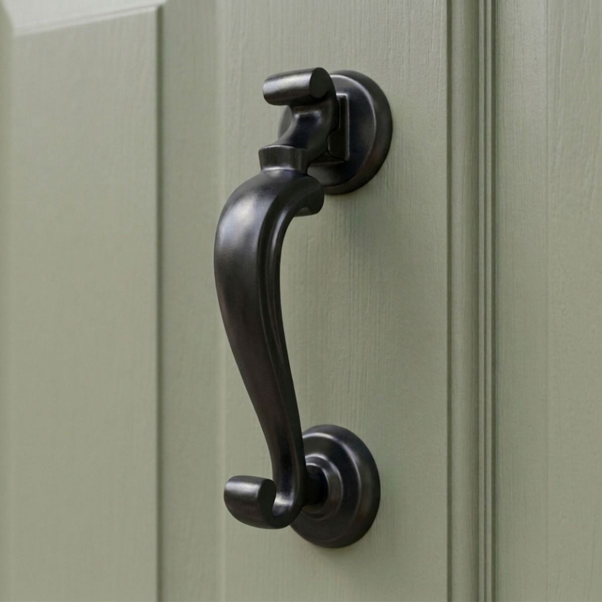The Smooth Black Steel Doctor"s Style Door Knocker on an Olive Green Front Door - Digital Illustration