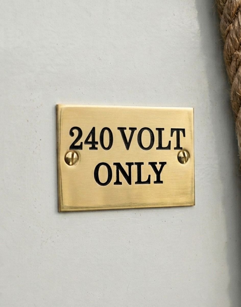The Solid Brass Plaque With Black Lettering Label that Reads  "240 volt Only" Shown Close up - Digital Illustration 